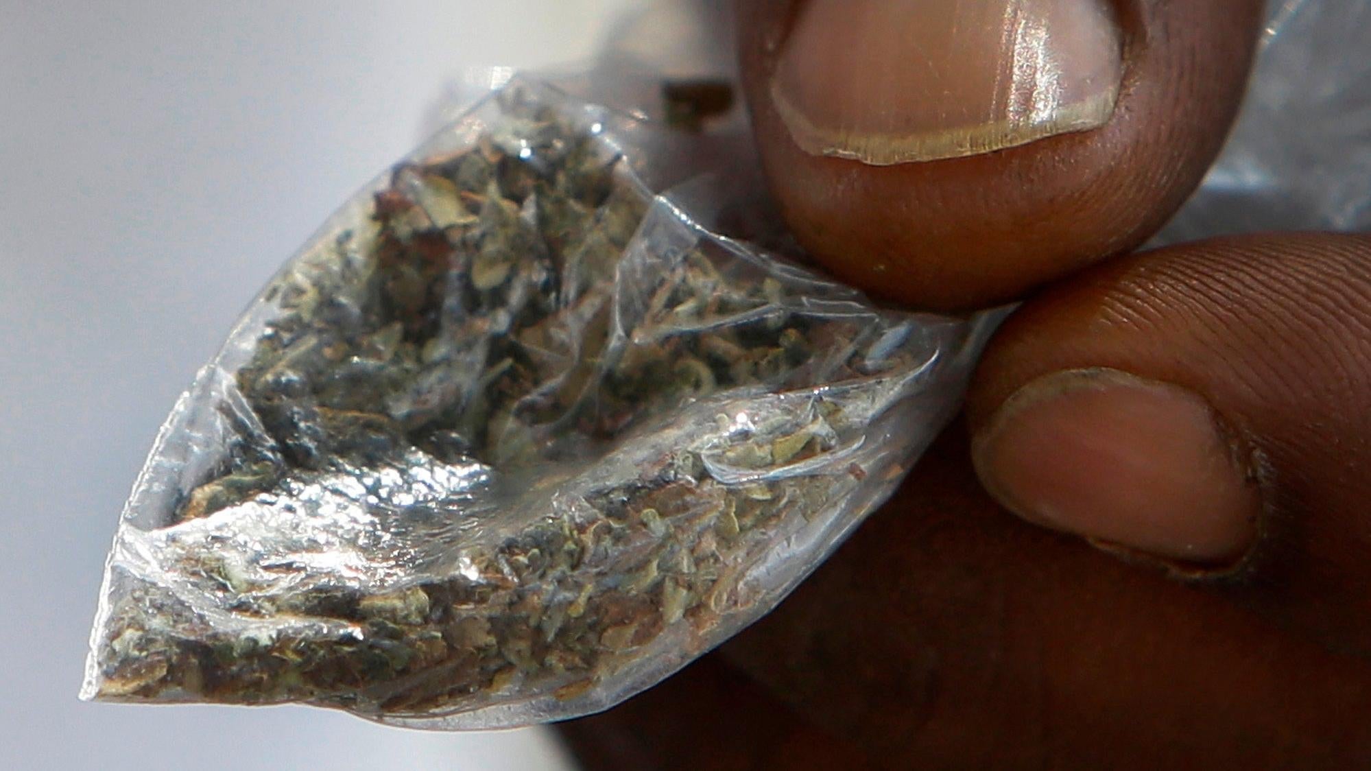 A man holds a bag of synthetic marijuana in Houston