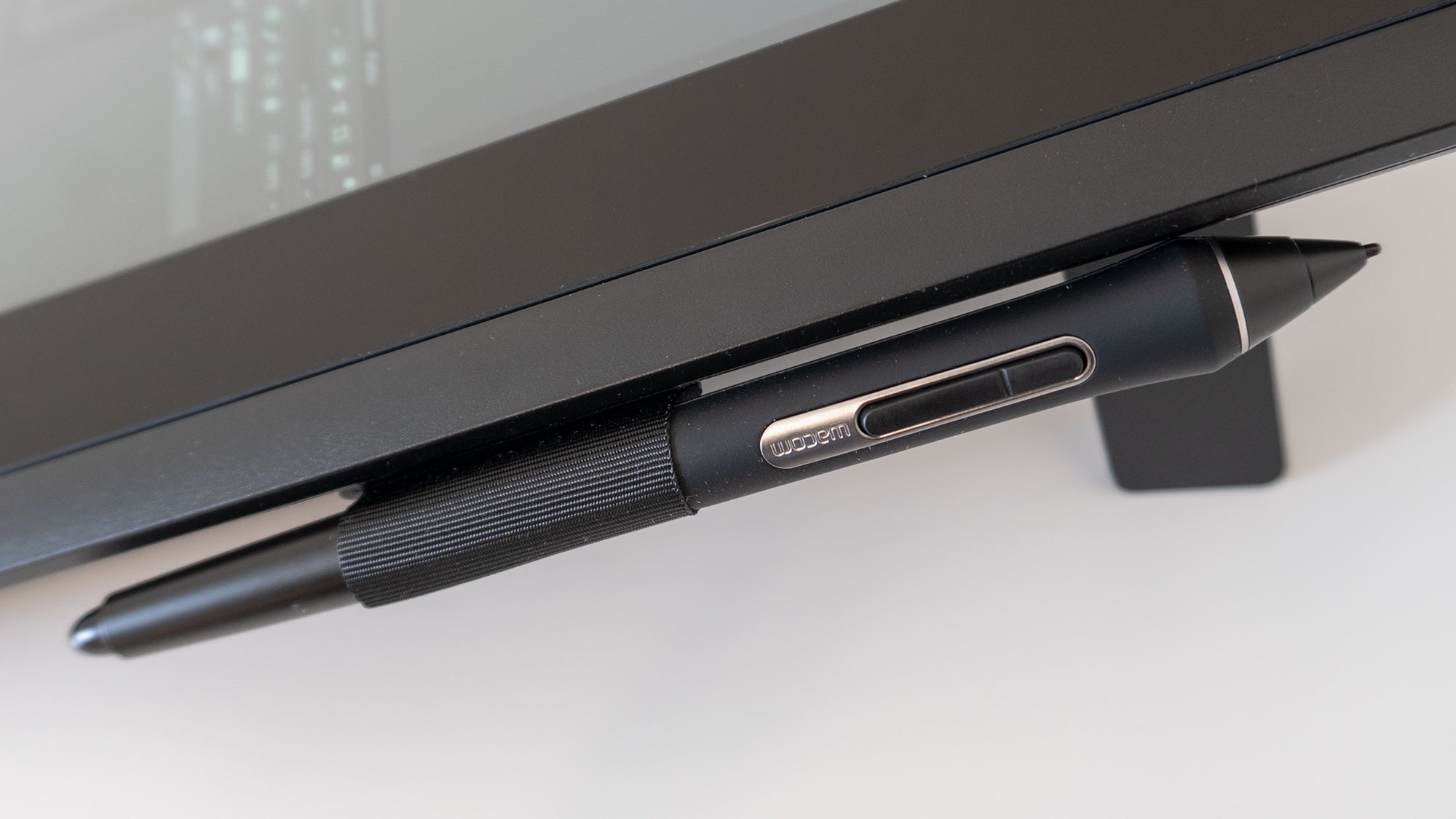 A fabric loop on the side of the Cintiq 16 provides a place to quickly and securely store its stylus.