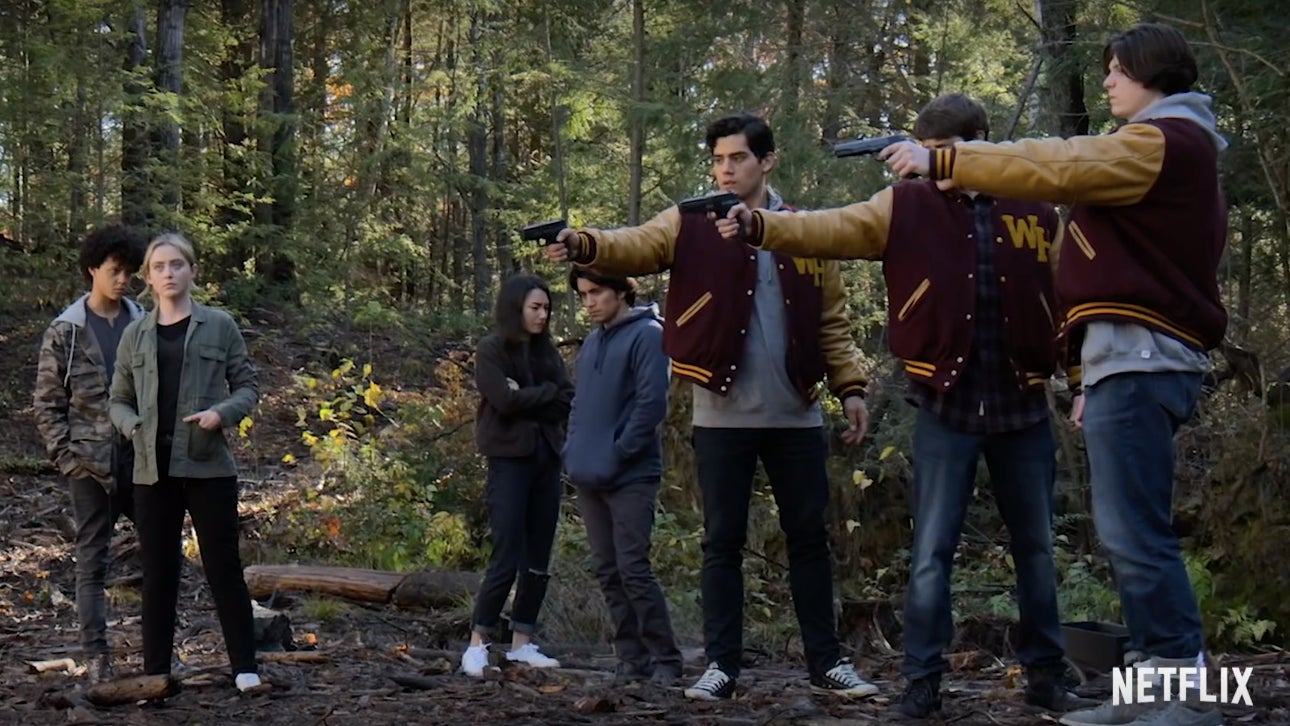 A group teenagers seemingly preparing to execute someone.