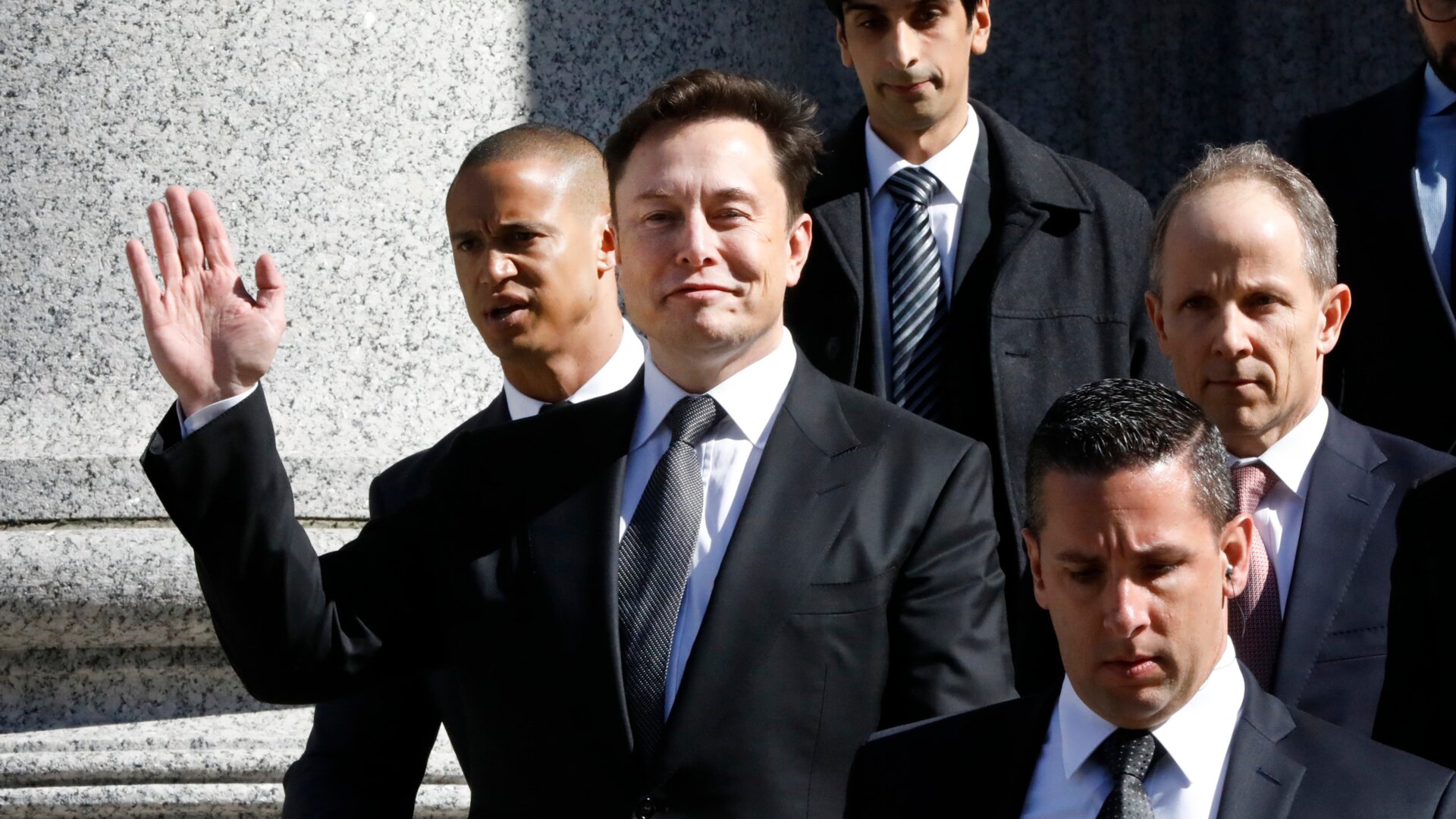 Tesla CEO Elon Musk waves as he leaves Manhattan Federal Court, in New York, Thursday, April 4, 2019.