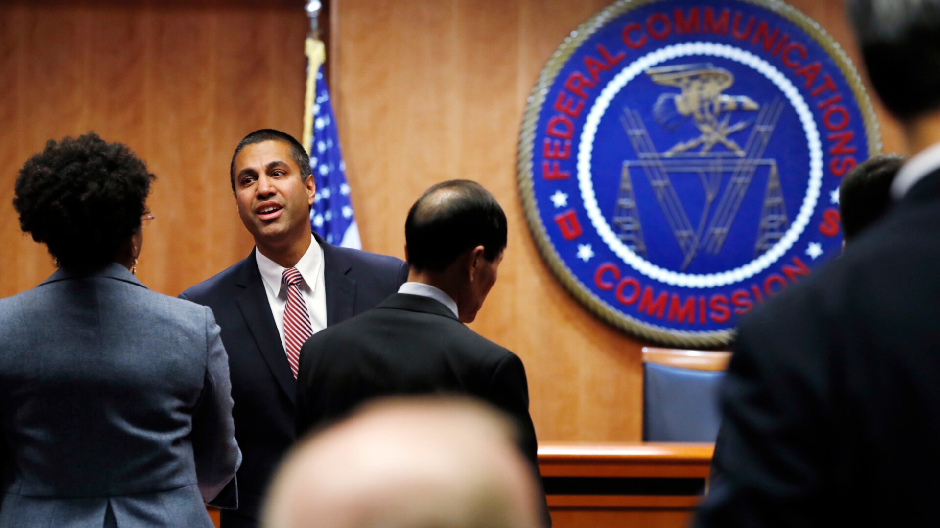 Federal Communications Commission (FCC) Chairman Ajit Pai, left, greets witnesses before the meeting where the FCC voted to repeal net neutrality, Dec. 14, 2017, in Washington.
