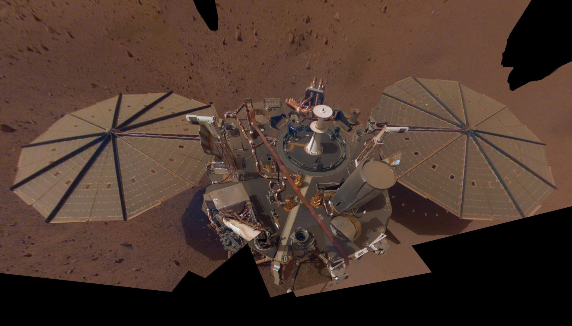 NASA’s InSight lander, with a thin coating of reddish dust seen on the solar panels.