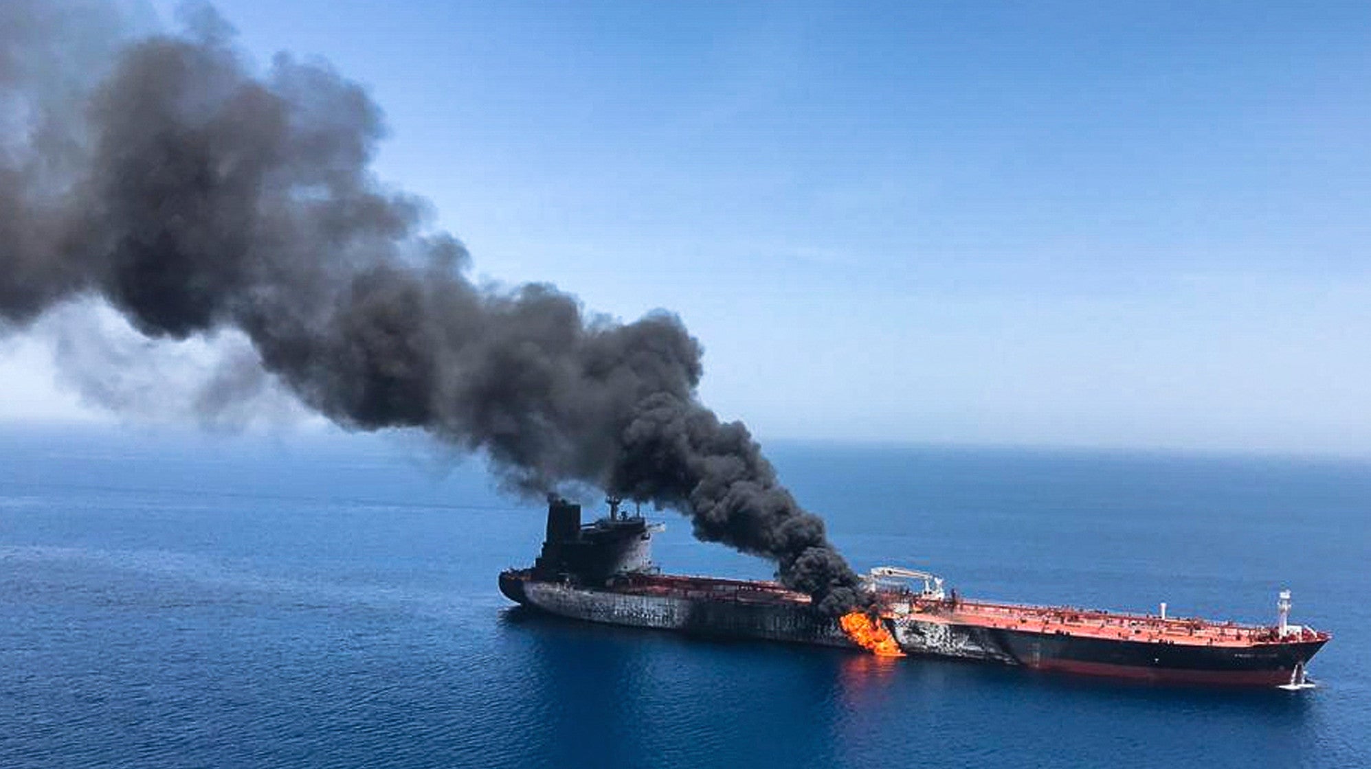 An oil tanker burning near the Strait of Hormuz, June 13, 2019.