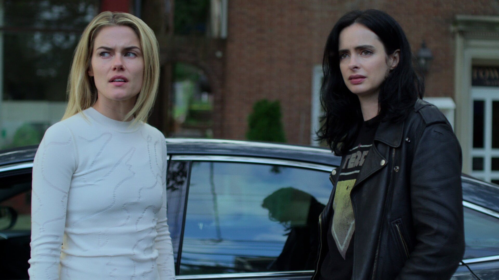Rachael Taylor as Trish Walker and Krysten Ritter as Jessica Jones, expressing their disdain for something.