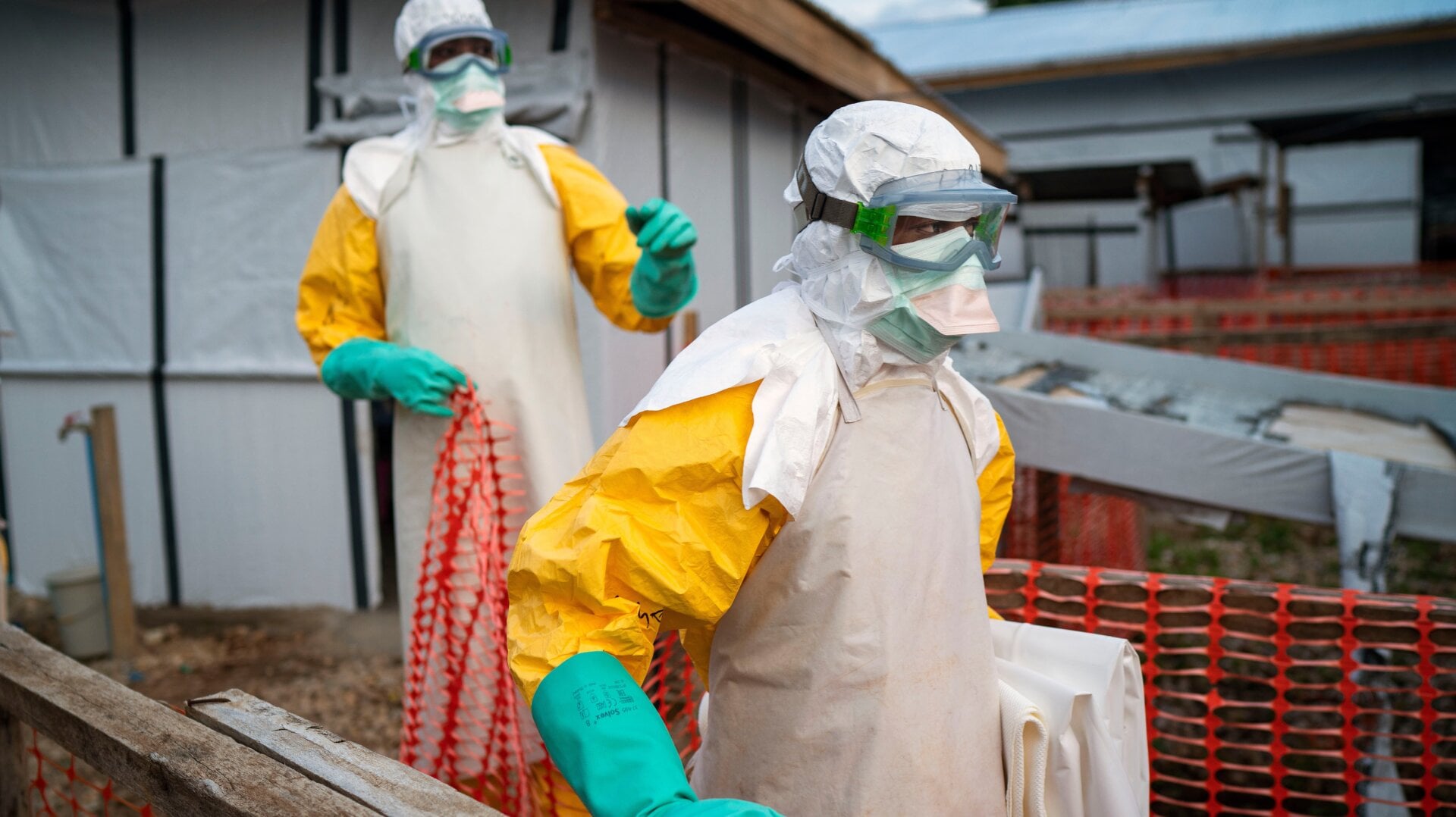 In this photograph taken Saturday July 13, 2019, health workers wearing protective suits take their shift at a treatment center in Beni, Congo DRC.