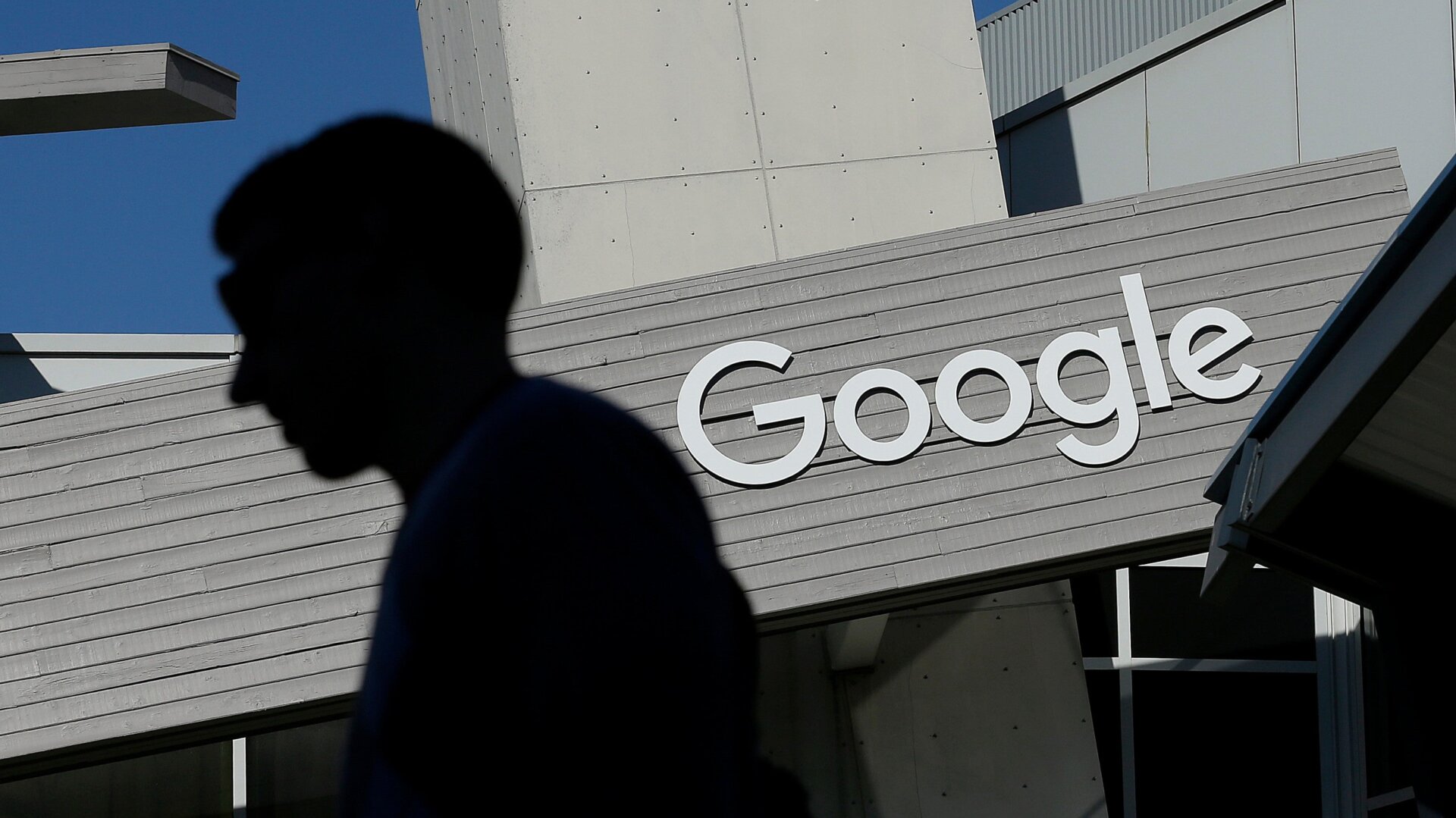 A man walking past a building at Google’s Mountain View, California headquarters in 2015.