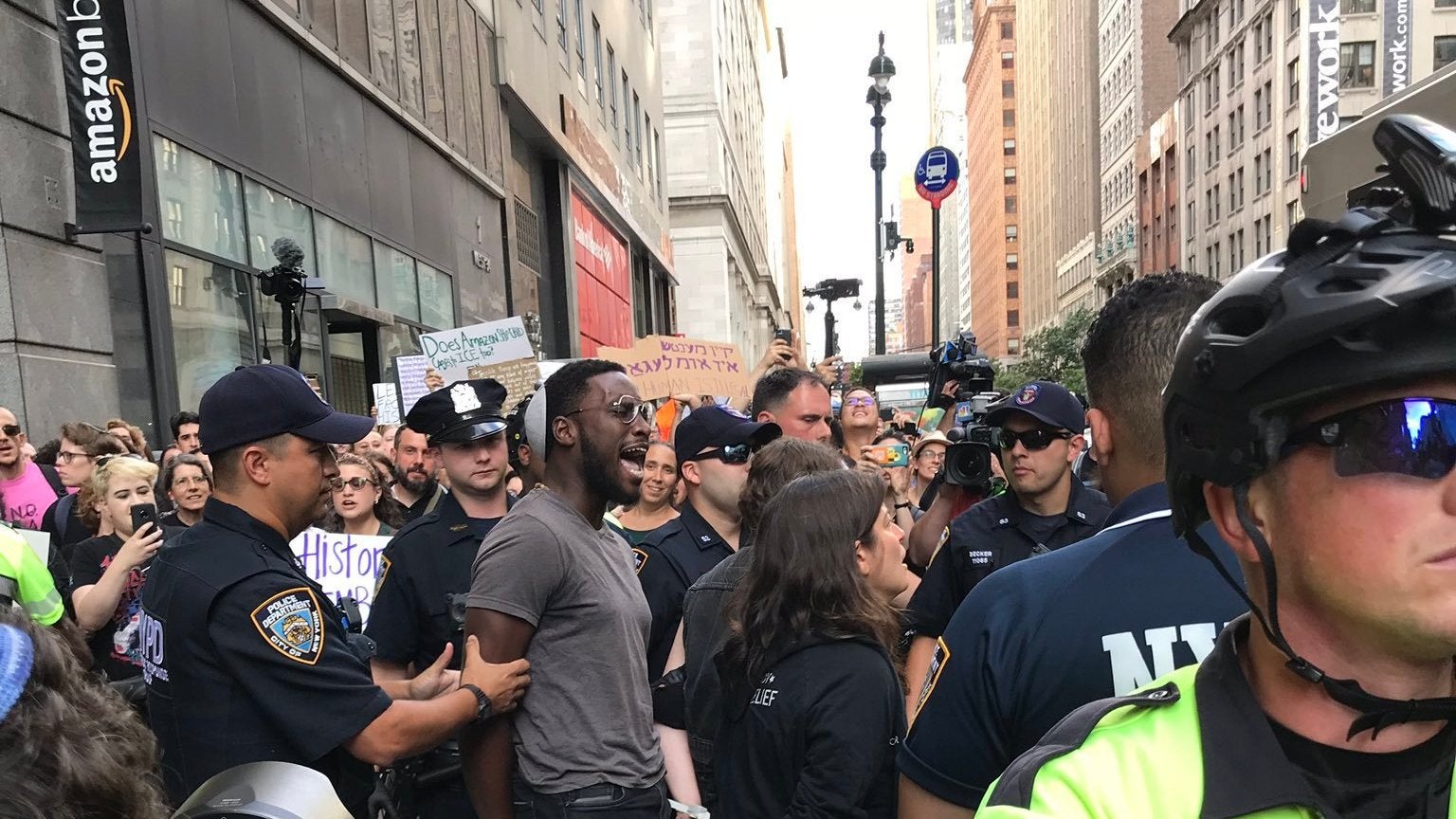 A photo released by Jews for Racial & Economic Justice of organizer Yehudah Webster being taken into custody at a protest against Amazon in Manhattan on Aug. 11, 2019.