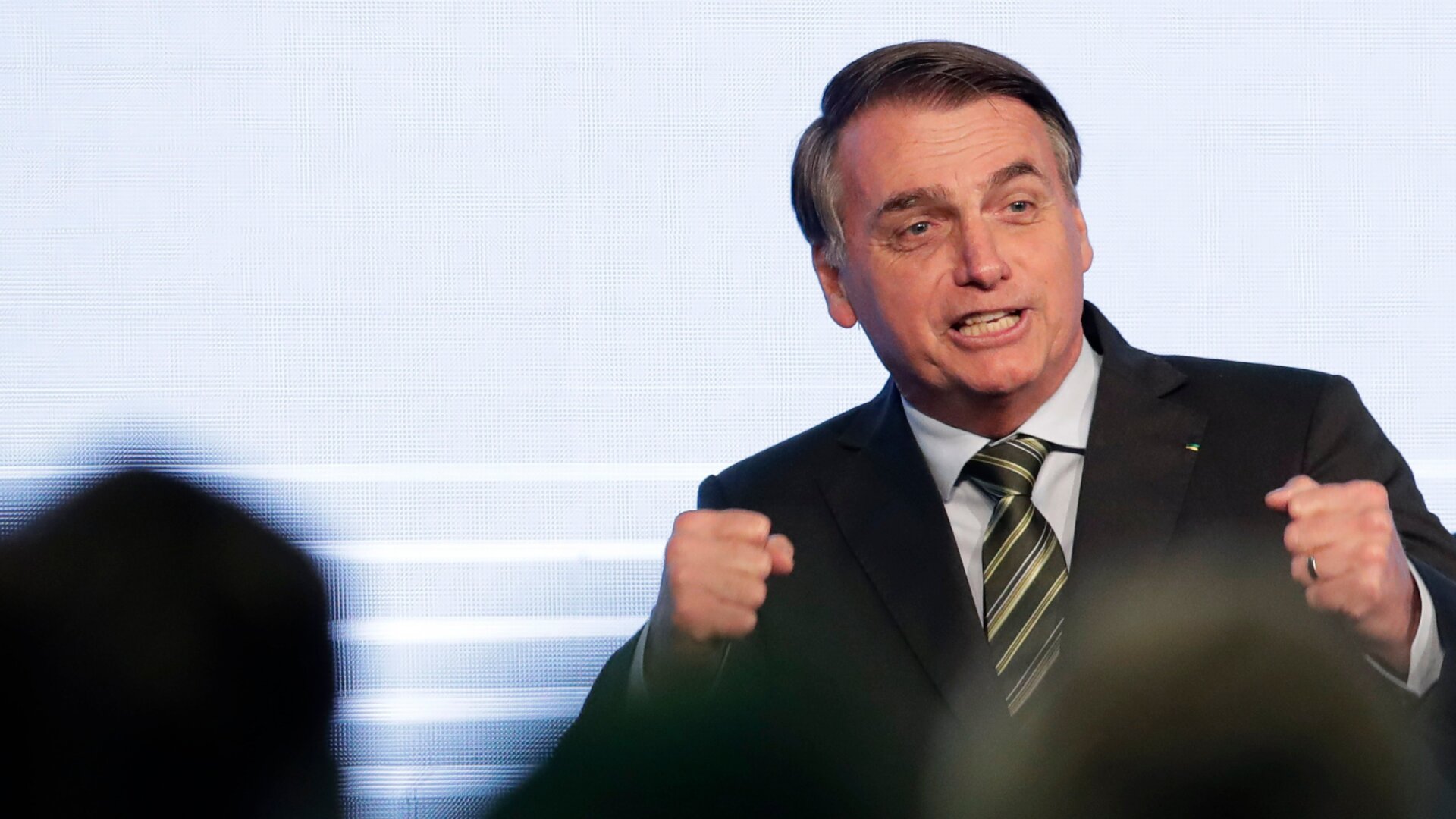 Brazilian President Jair Bolsonaro speaking to a steel industry meeting, where he falsely claimed NGOs are burning down the Amazon in retaliation for budget cuts, on Wednesday.