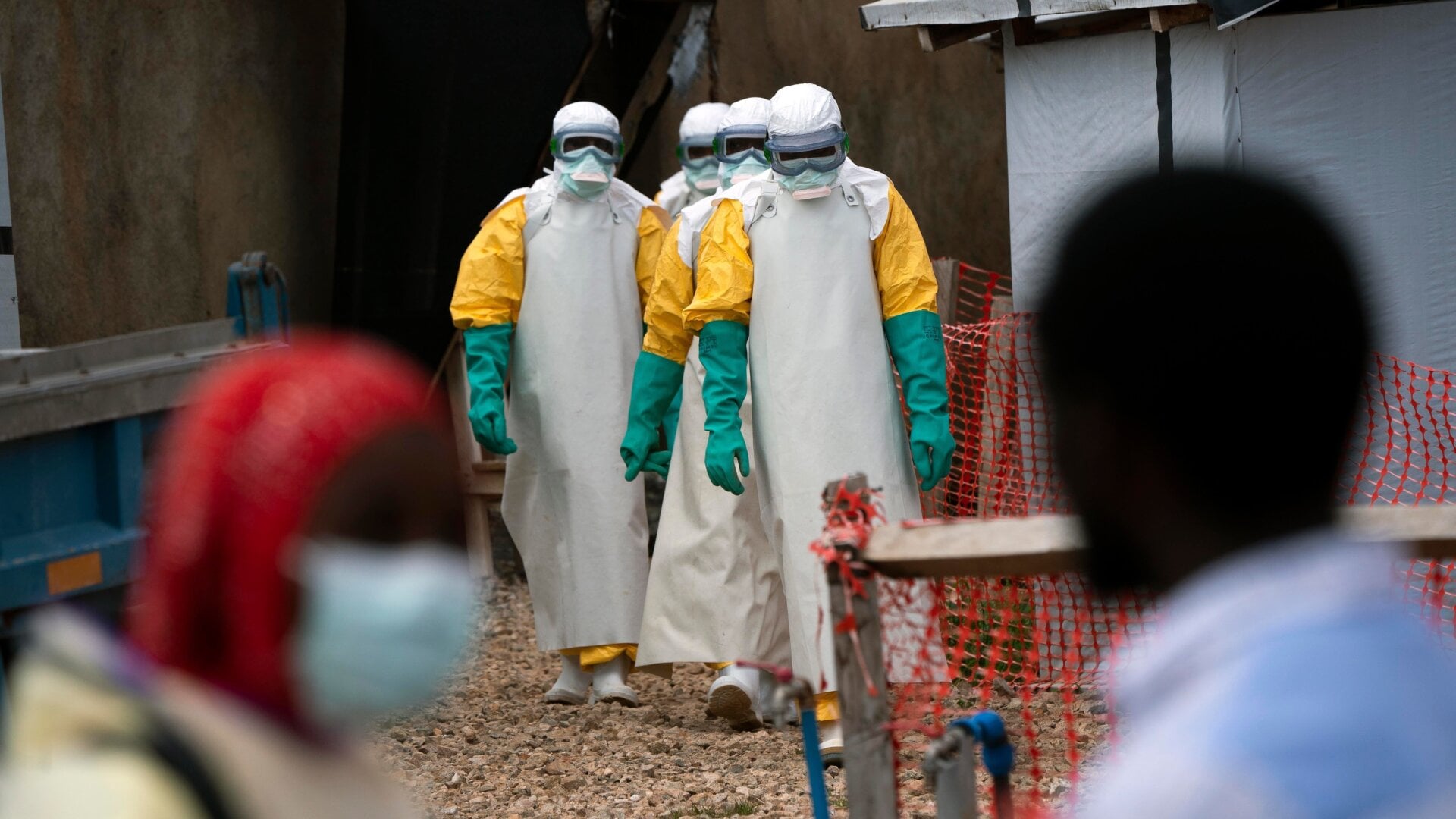 Health workers in protective gear start their shift at an Ebola treatment center in Beni, Congo DRC.