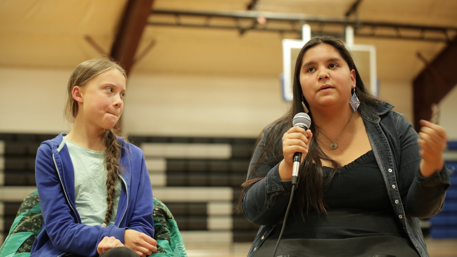 Greta Thunberg, 16, sits next to Tokata Iron Eyes, 16, during the panel Sunday at the Pine Ridge Reservation in South Dakota.