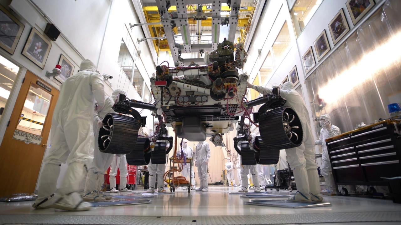 The Mars 2020 rover being lowered onto its wheels.