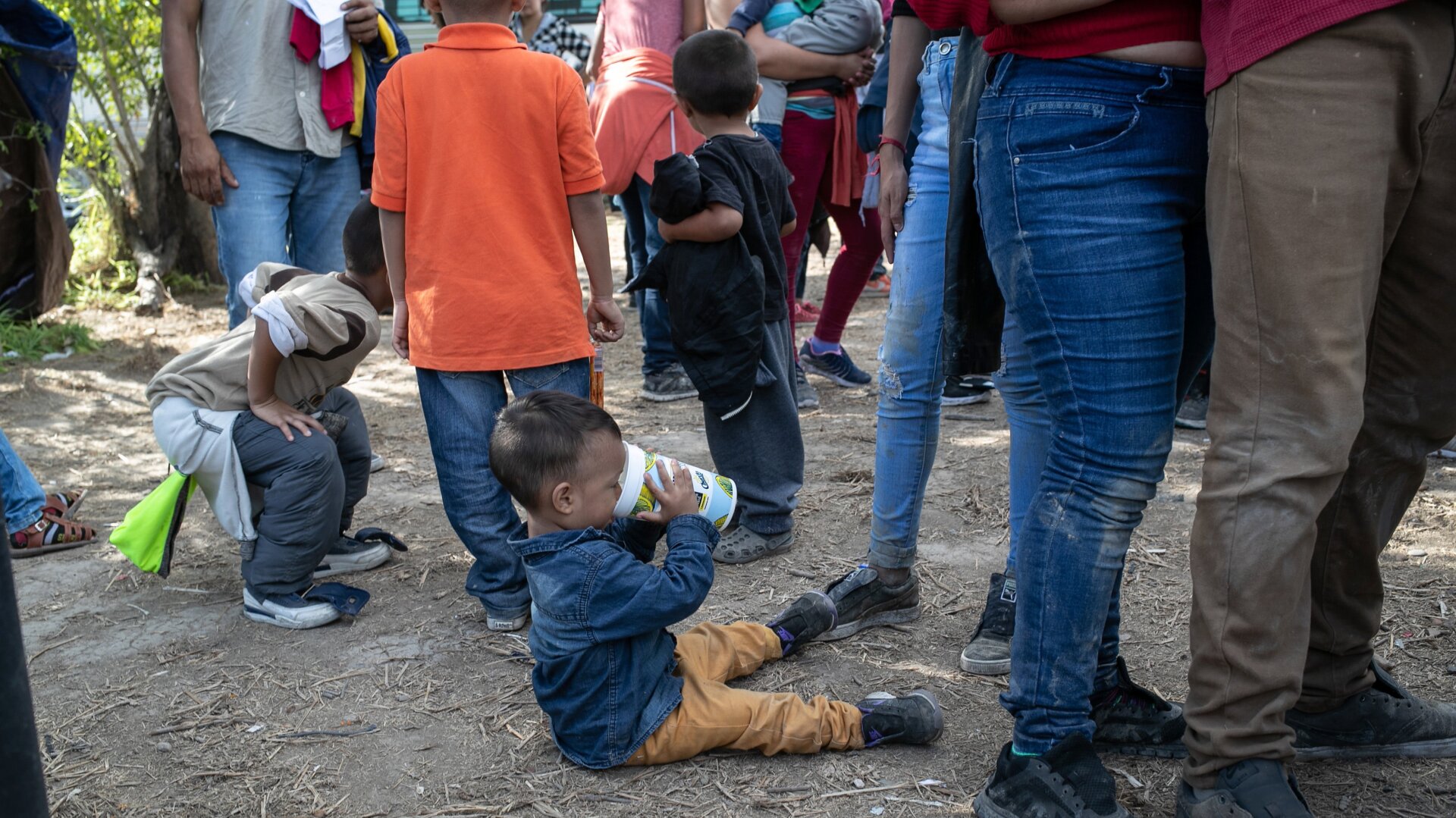 Immigrants wait to speak with U.S. Border Patrol agents before being transferred to the McAllen Border Patrol facility on July 02, 2019 in Los Ebanos, Texas.