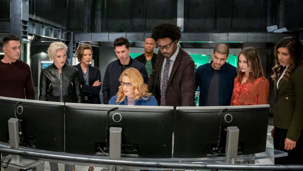 The gang’s all here. (L-R): Colton Haynes as Roy Harper, Katie Cassidy as Laurel Lance/Black Siren, Audrey Marie Anderson as Lyla Michaels, Joe Dinicol as Rory Regan/Ragman, Emily Bett Rickards as Felicity Smoak, David Ramsey as John Diggle/Spartan, Echo Kellum as Curtis Holt/Mr. Terrific, Rick Gonzalez as Rene Ramirez/Wild Dog, Willa Holland as Thea Queen, and Juliana Harkavy as Dinah Drake/Black Canary.