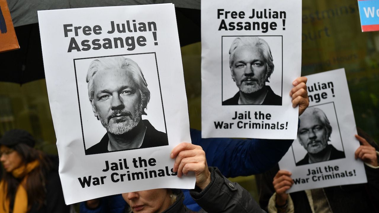 Demonstrators hold placards calling for WikiLeaks founder Julian Assange outside Westminster Magistrates Court in London on October 21, 2019