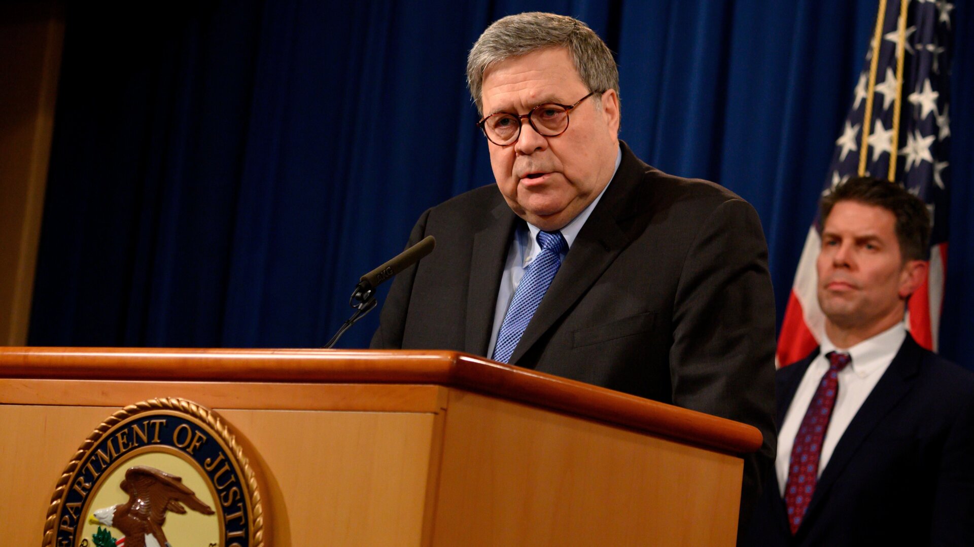 US Attorney General, William Barr (L), and FBI Deputy Director David Bowdich (R) hold a press conference, regarding the December 2019 shooting at the Pensacola Naval air station in Florida, at the Department of Justice in Washington, DC on January 13, 2020.