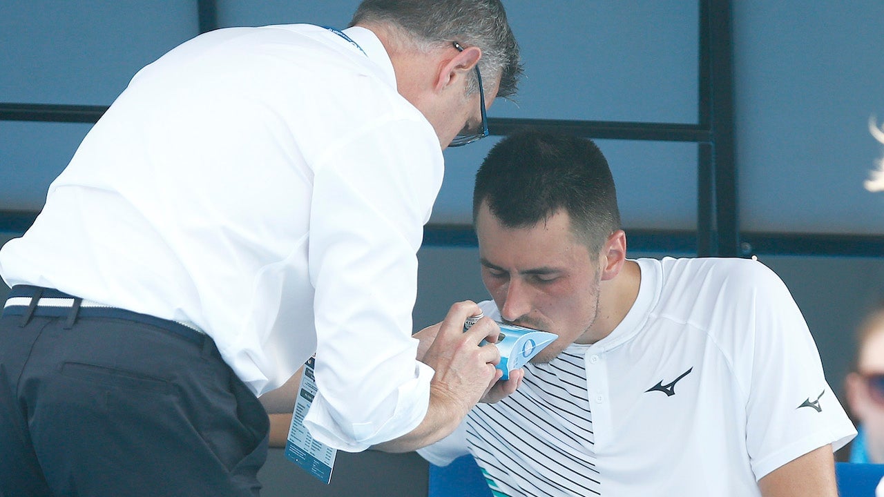 Bernard Tomic of Australia receives medical attention during his match against Denis Kudla of the U.S. during 2020 Australian Open Qualifying on January 14, 2020 in Melbourne, Australia.