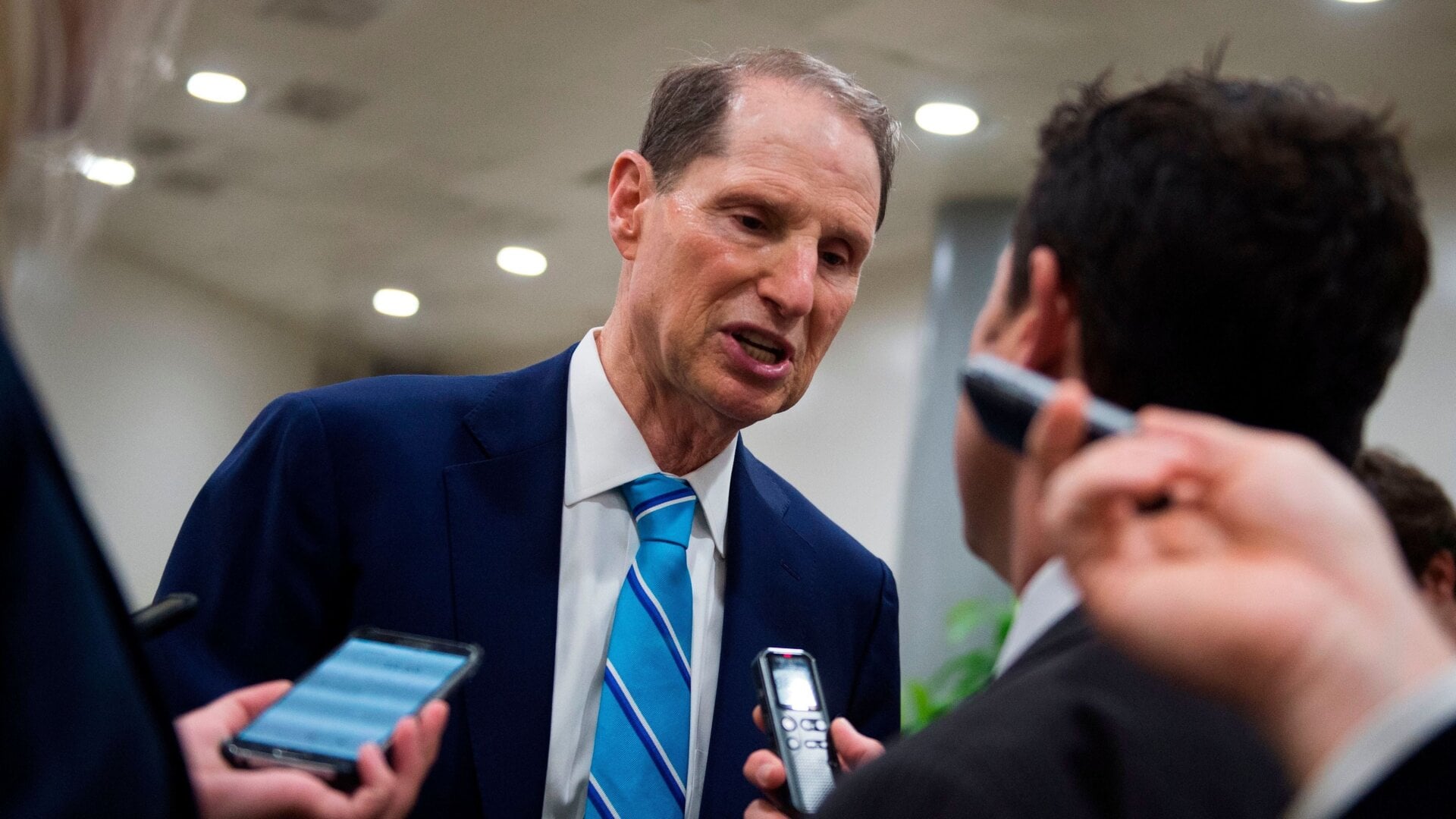 US Senator Ron Wyden, Democrat of Oregon, speaks to reporters as he walks to the chamber to go for a vote on July 17, 2018 on Capitol Hill in Washington, DC.
