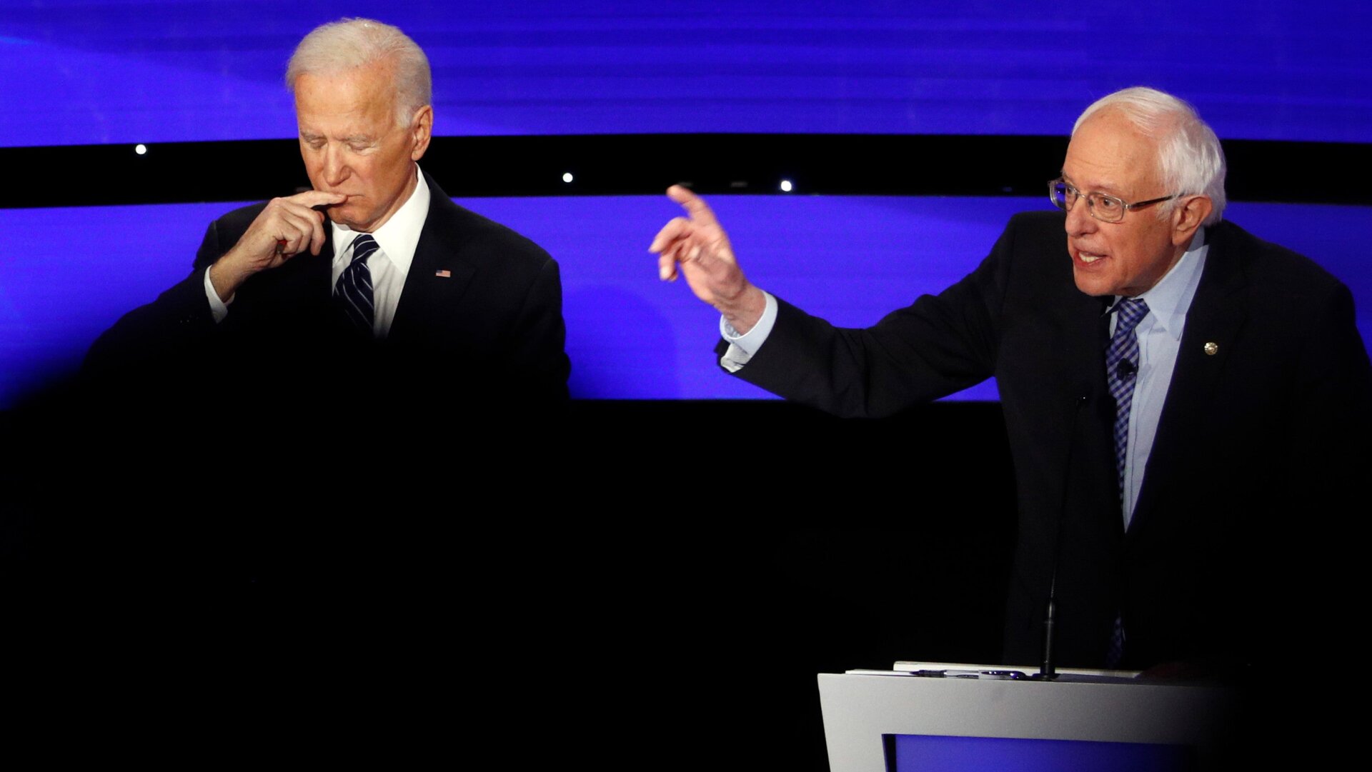 Former Vice President Joe Biden, left, and Vermont Senator Bernie Sanders, right, at a January 2020 presidential primary debate in Des Moines, Iowa.