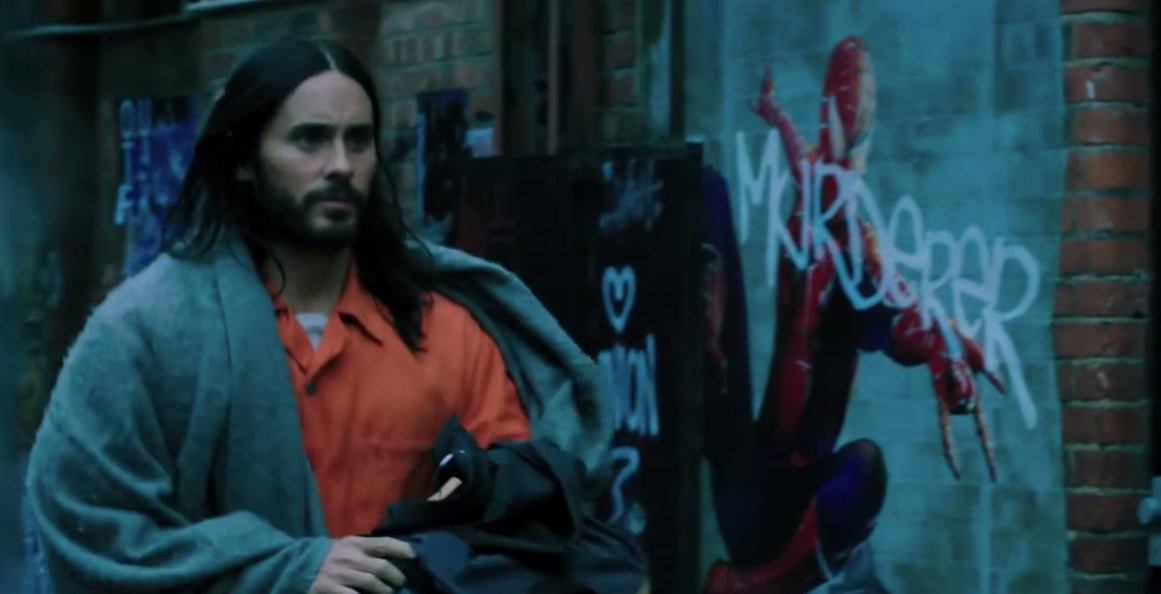 Michael Morbius passing by an image of Spider-Man.