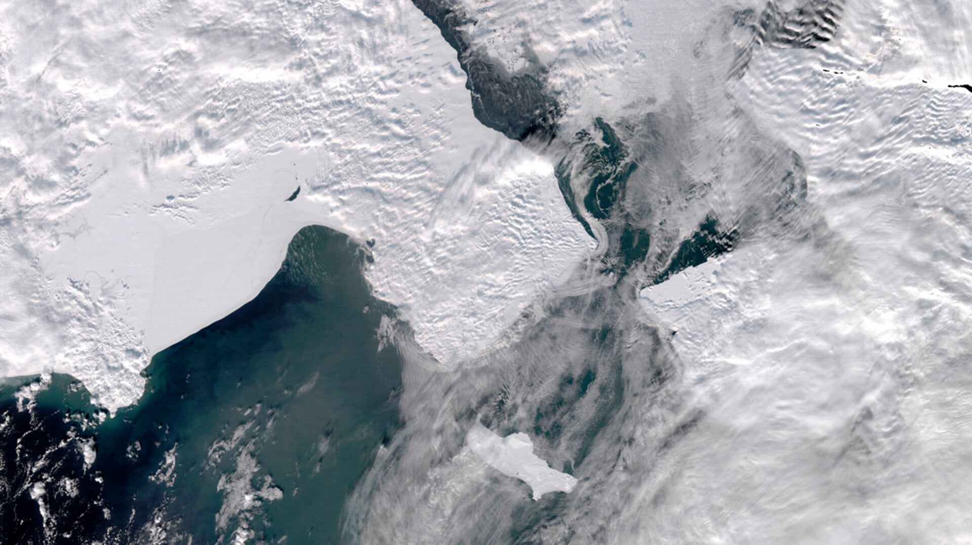 A satellite photo provided by the University of Alaska Fairbanks’ Geographic Information Network of Alaska shows clouds partially covering open water in the northern Bering Sea, the Bering Strait and the Chukchi Sea on March 4, 2019