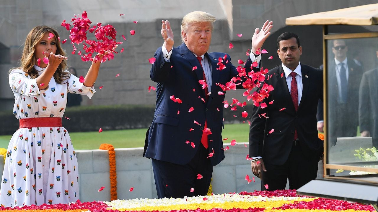 President Donald Trump and First Lady Melania Trump spray rose petals to pay tribute at Raj Ghat, the memorial for Mahatma Gandhi, in New Delhi, India on February 25, 2020.
