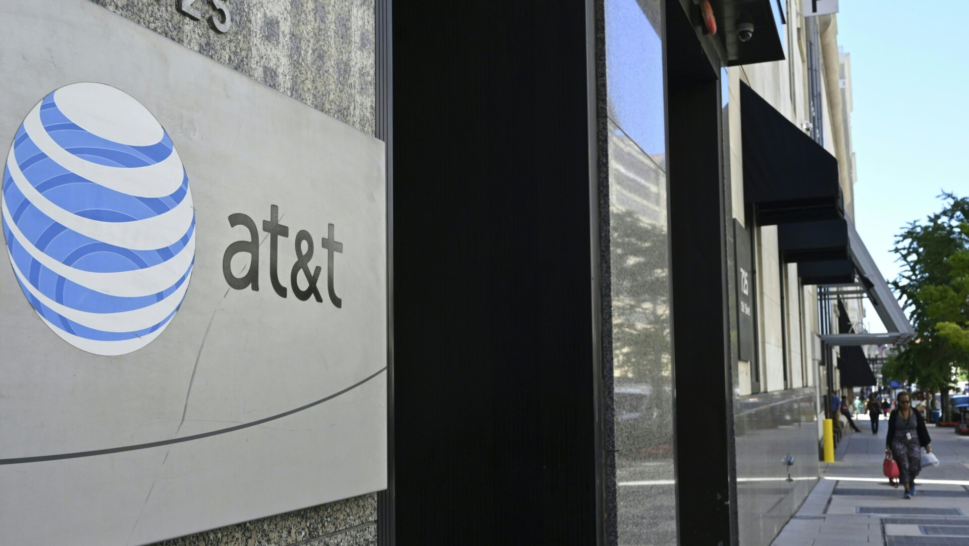 An AT&T telecommunication logo is seen at the entrance of a building in Washington, DC June 11, 2019.