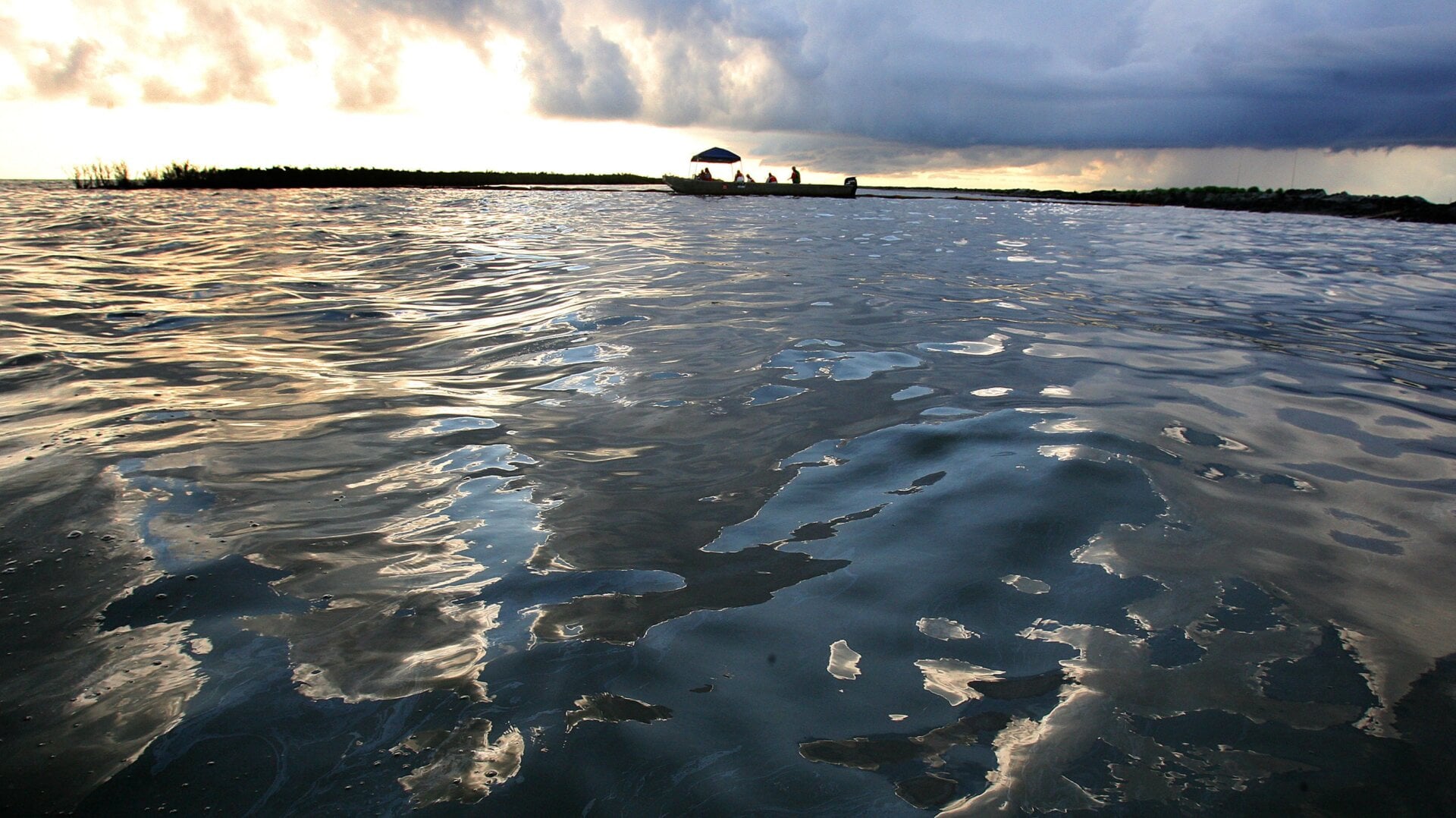 OIl sheen sits on the surface of Barataria Bay June 19, 2010 west of Port Sulpher, Louisiana.