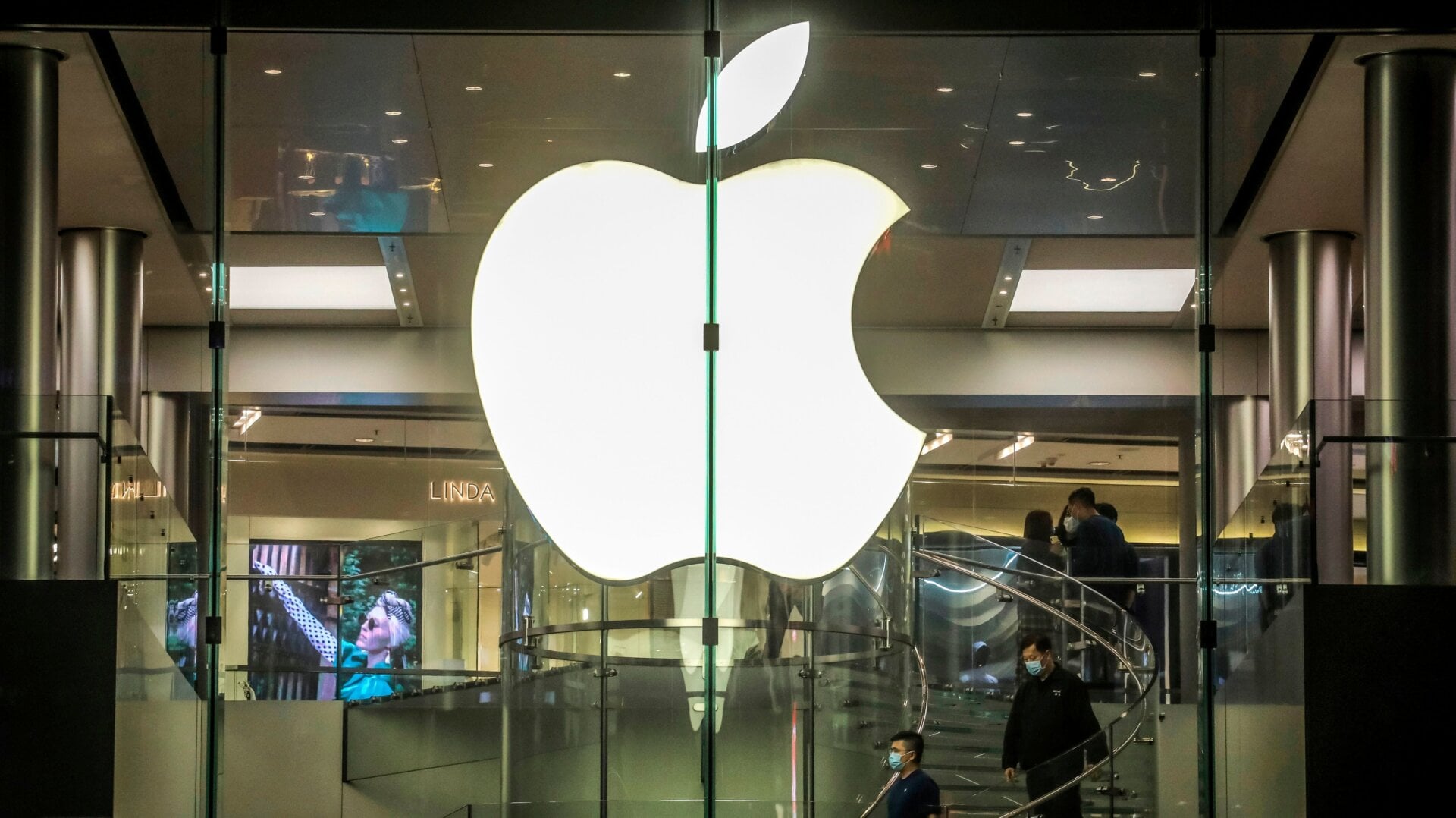 Customers wearing protective facemasks visit an Apple store in Hong Kong on February 22, 2020.