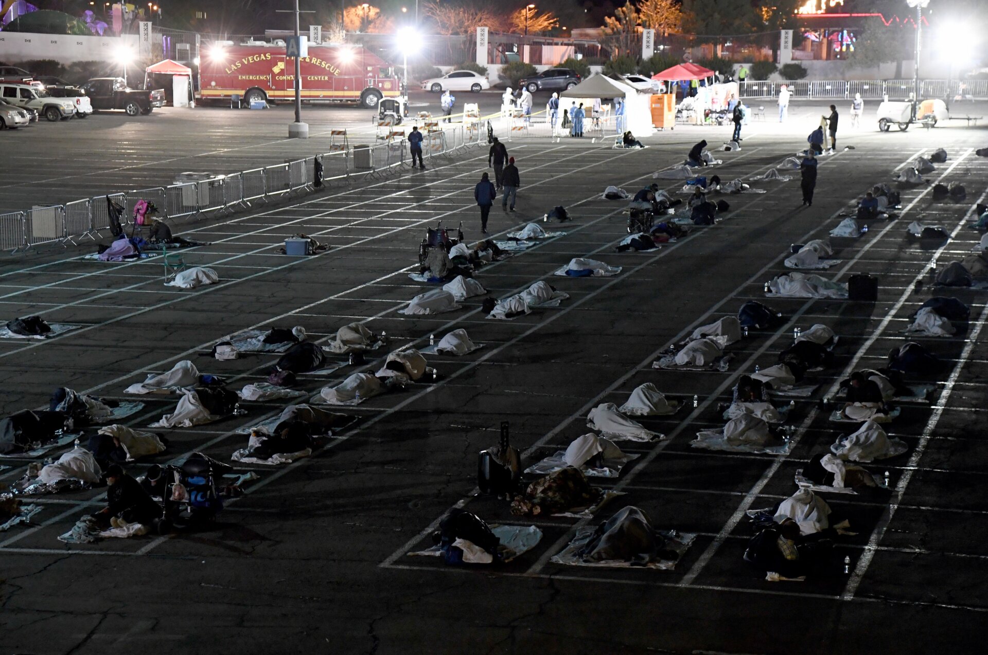 People are shown in social-distancing boxes at a so-called “temporary homeless shelter” set up in a parking lot at Cashman Center on March 30, 2020 in Las Vegas, Nevada.