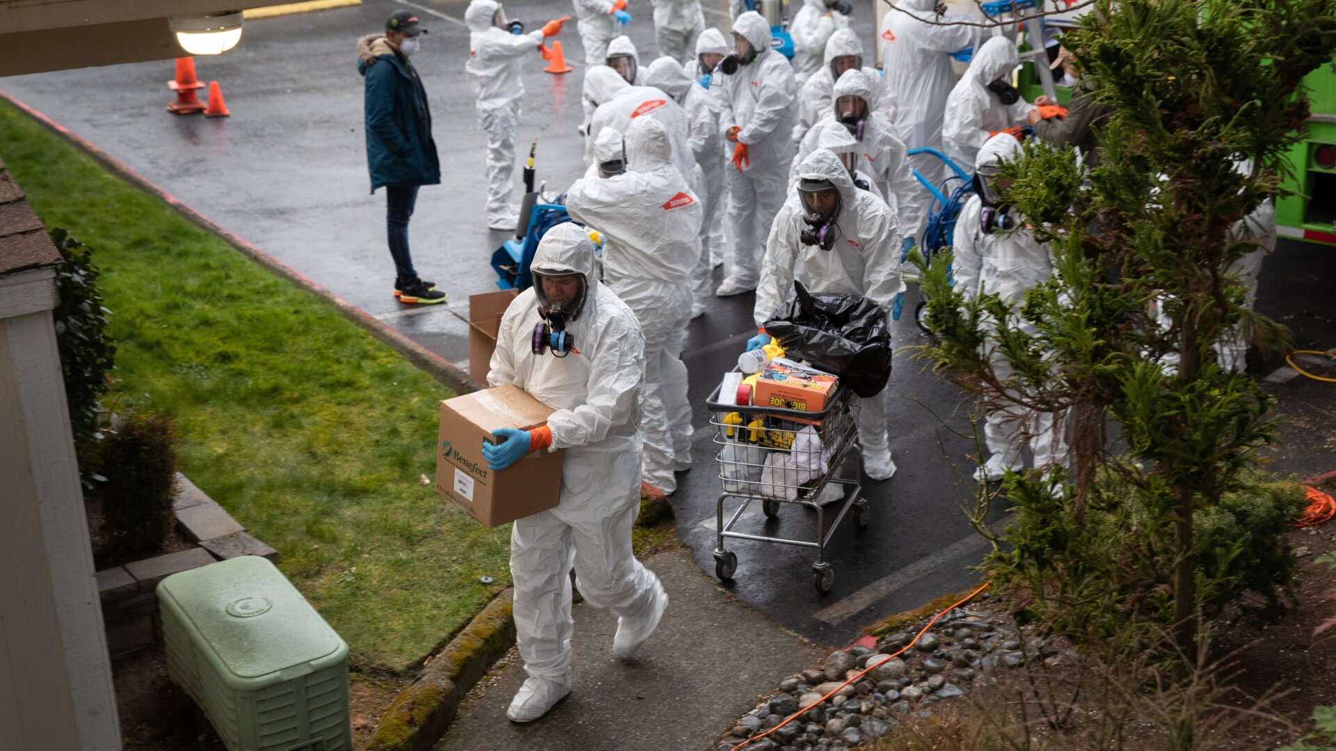 A cleaning crew takes disinfecting equipment into the Life Care Center, a nursing home connected to at least 29 covid-19 deaths, on March 12, 2020 in Kirkland, Washington.