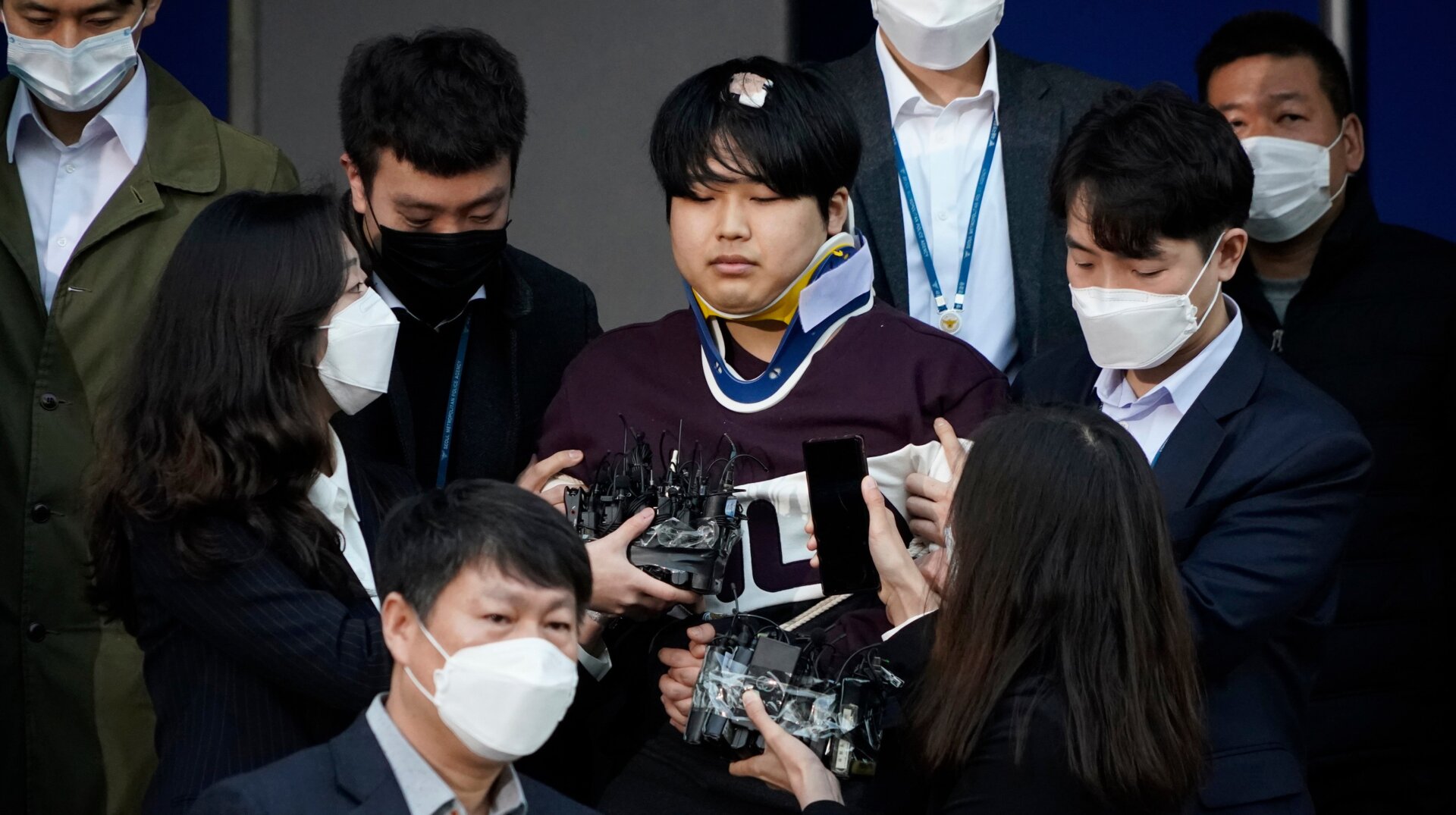 Cho Ju-bin, leader of South Korea’s online sexual blackmail ring which is so called “Nth room,” is surrounded by journalists while walking out of a police station as he is transferred to prosecutors’ office for further investigation in Seoul, South Korea, Wednesday, March 25, 2020.