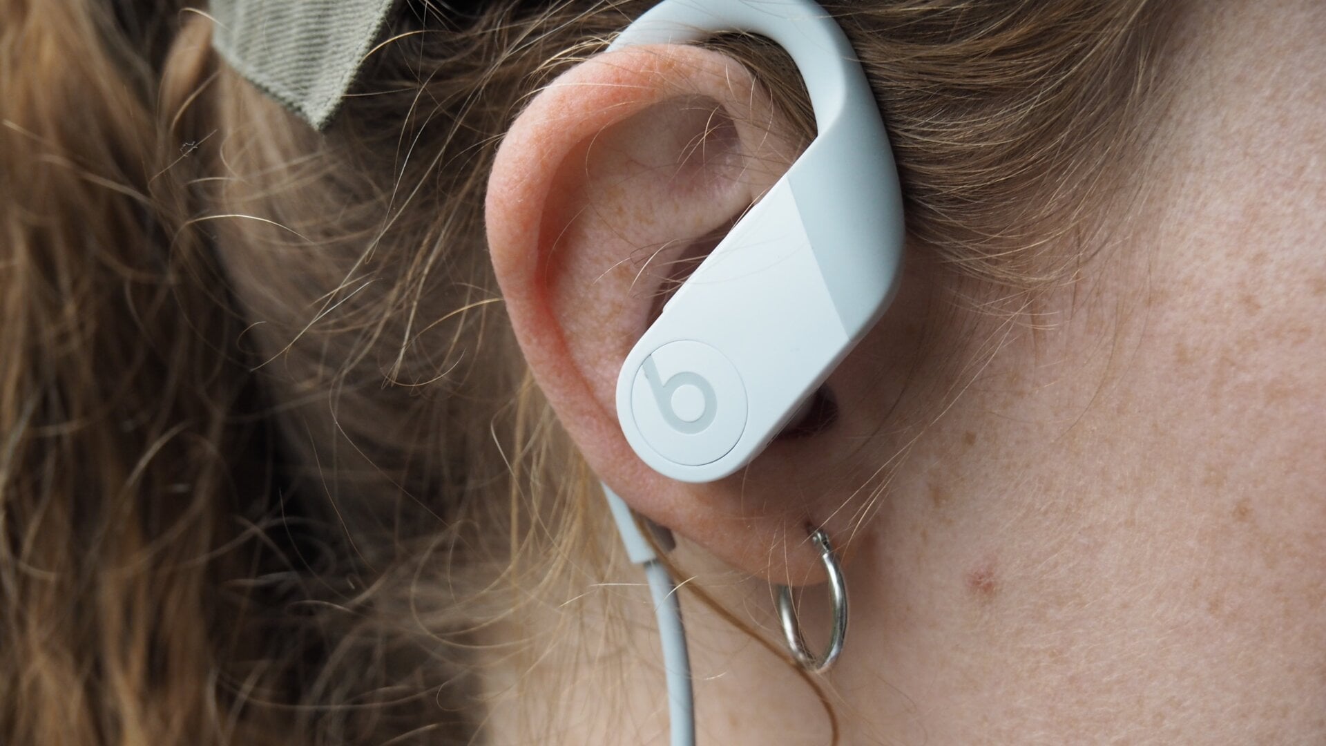 Powerbeats 4 offer a secure fit with an around-the-ear hook and a cord that connects the earbuds.