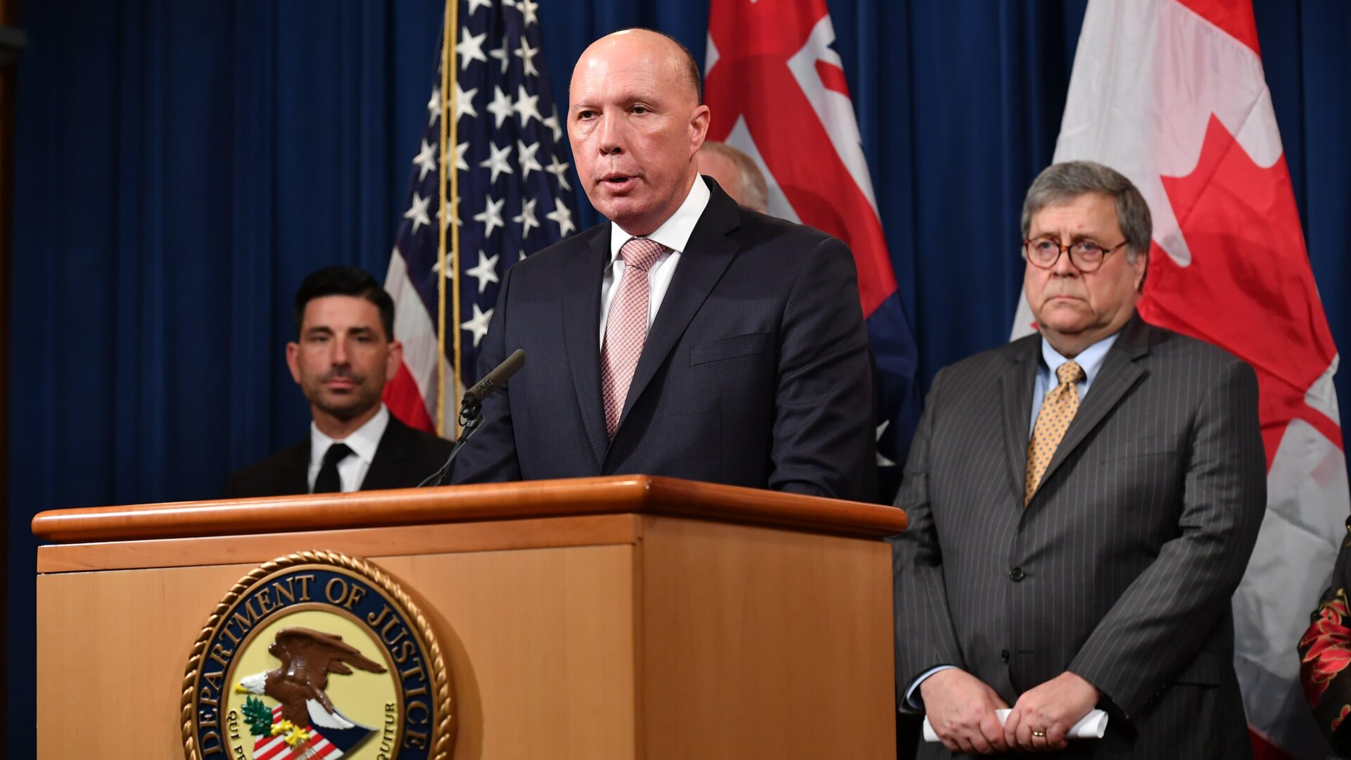 Australia’s Minister for Home Affairs Peter Dutton (center) on March 5, 2020 during a press conference at the Department of Justice in Washington, D.C. with Homeland Security Secretary Chad Wolf (left) and Attorney General William Barr (right)