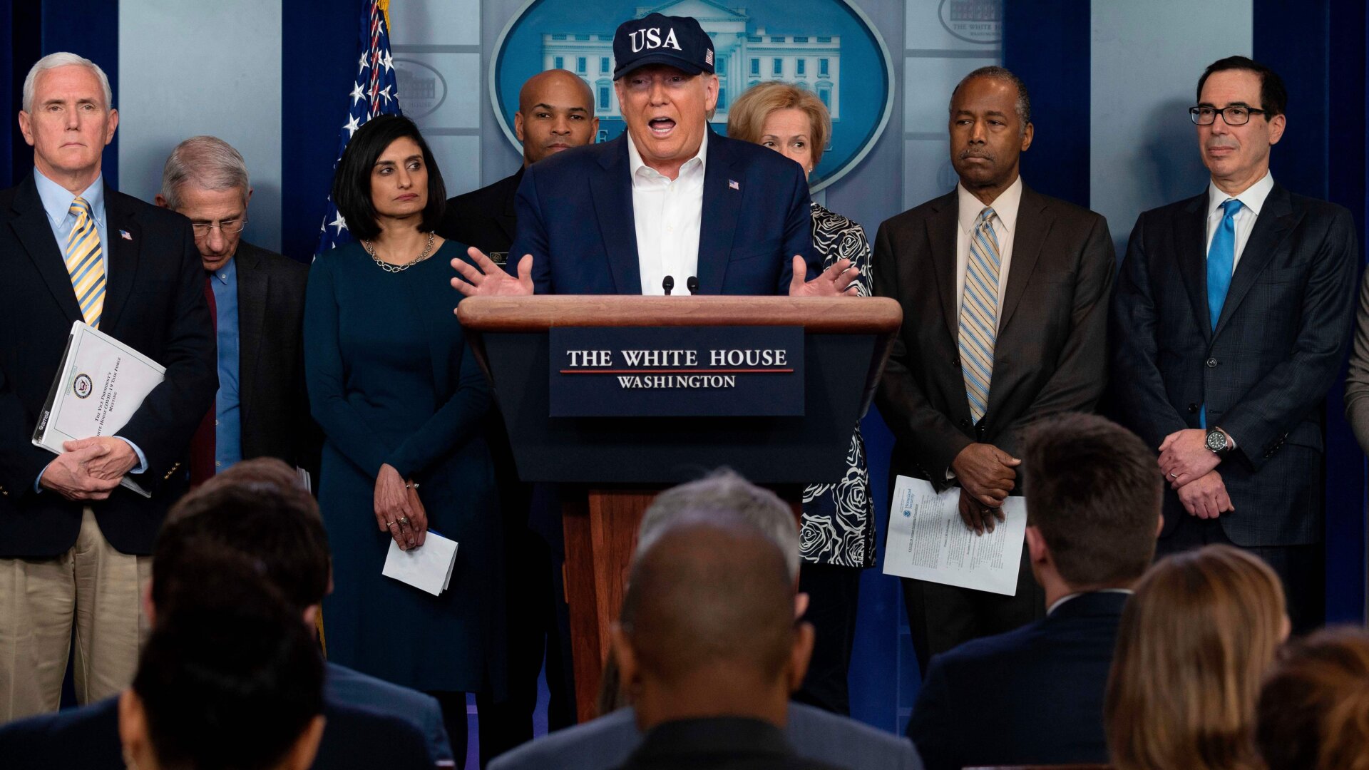 President Donald Trump, surrounded by members of the White House’s Coronavirus Task Force, discusses the national emergency at a Saturday press conference.