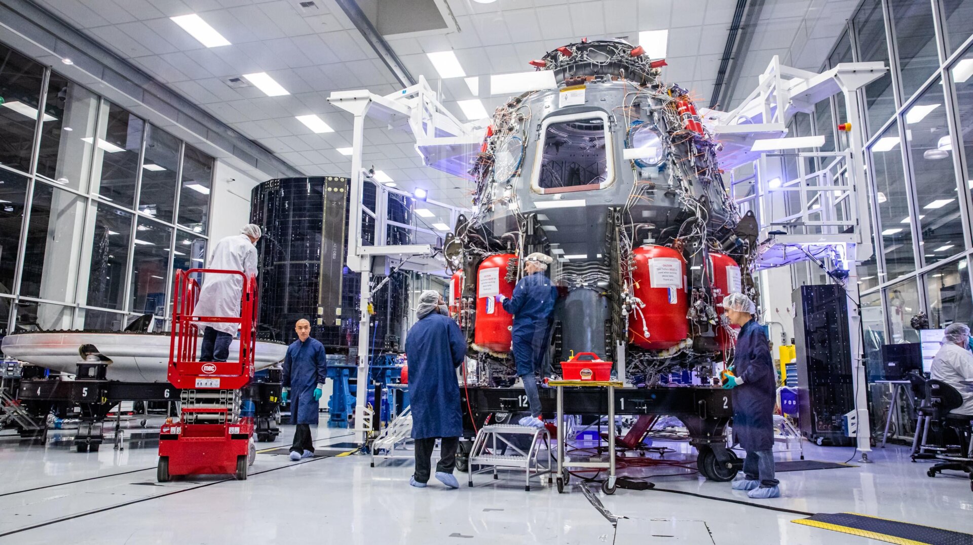 SpaceX staff work on the Crew Dragon reusable spacecraft in October 2019.