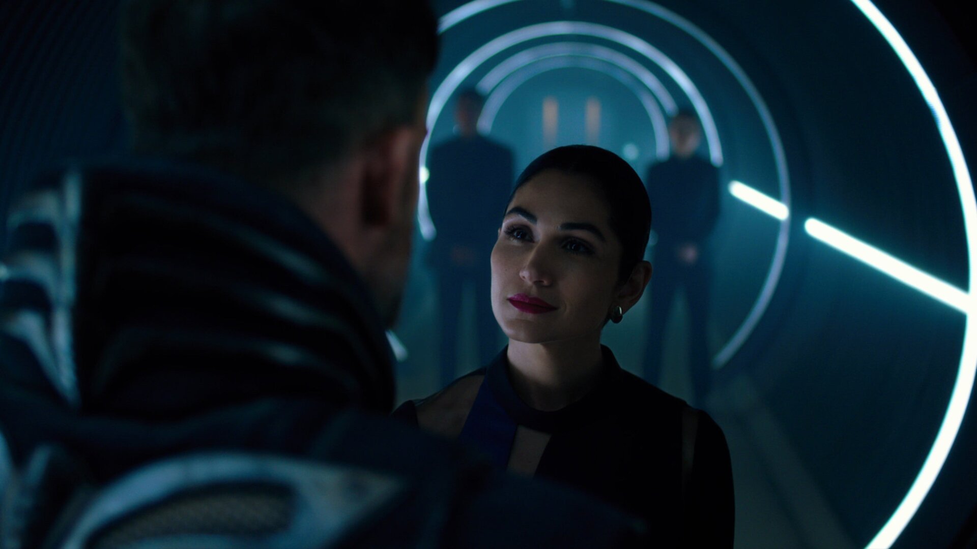 Danica Harlan (Lela Loren) tells Carrera (Torben Liebrecht) what’s what. 