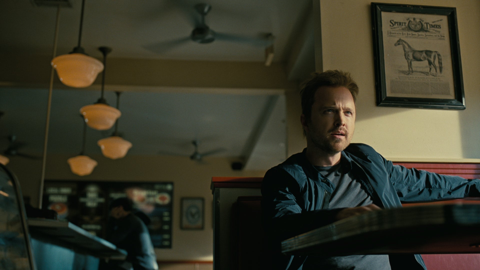 Caleb (Aaron Paul) hears a pitch. 