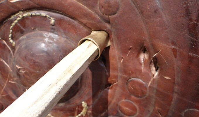 A spear penetrating a shield.