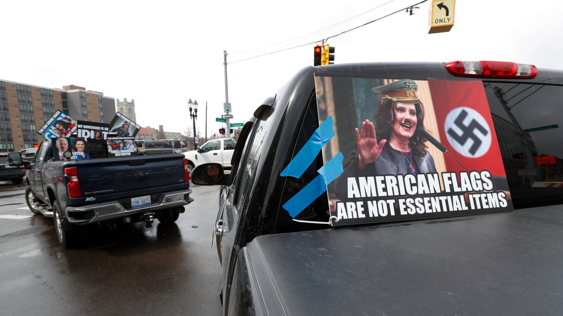 A sign comparing Governor Whitmer to Adolf Hitler at a protest in Michigan on April 15, 2020.