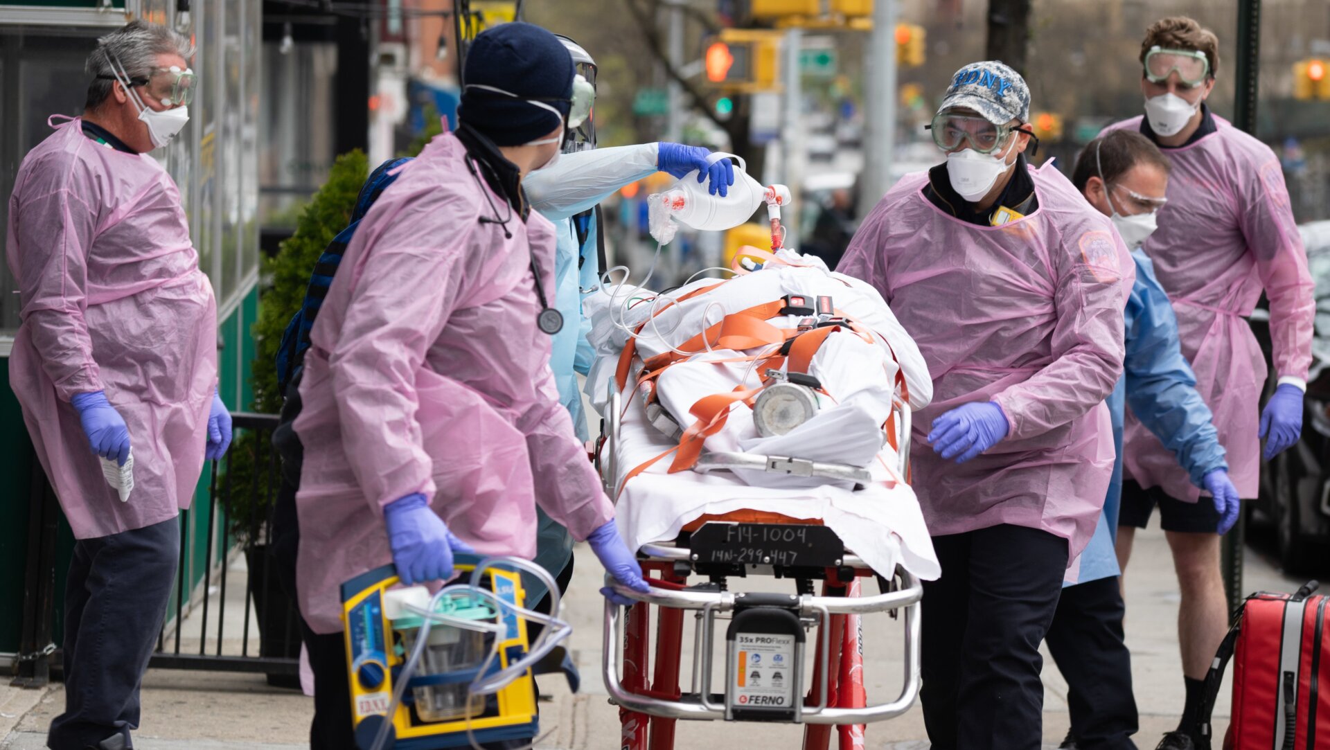 Fire Department of New York medical staff attend to an elderly person experiencing difficulty breathing outside of an apartment building on April 20, 2020, in New York City.