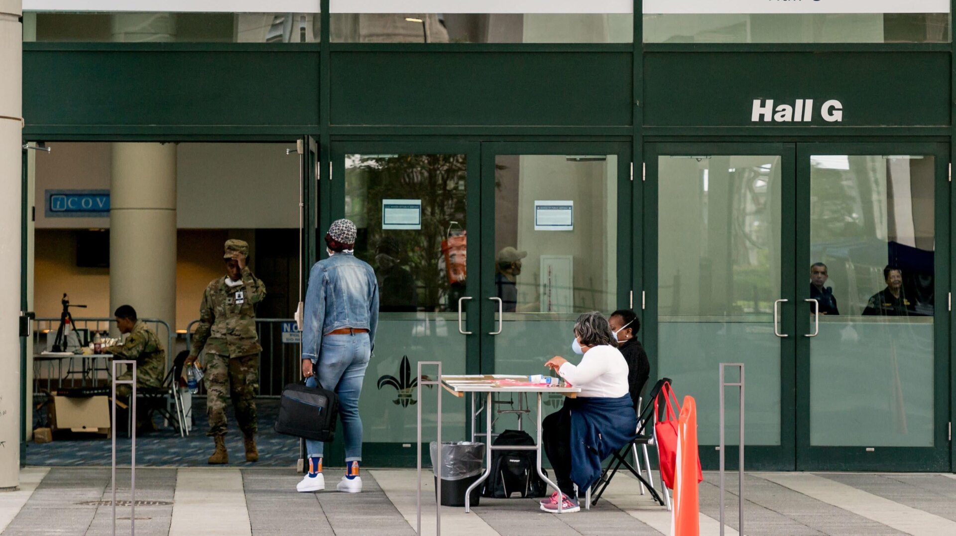 A woman enters the New Orleans Ernest N. Morial Convention Center on April 6, 2020.
