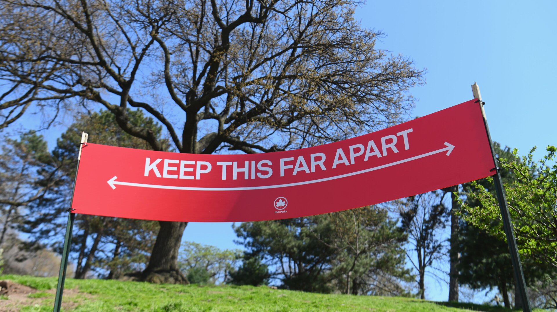 A sign reading ‘Keep This Far Apart’, to remind people of social distancing, is seen in a park on April 15, 2020 in New York City.