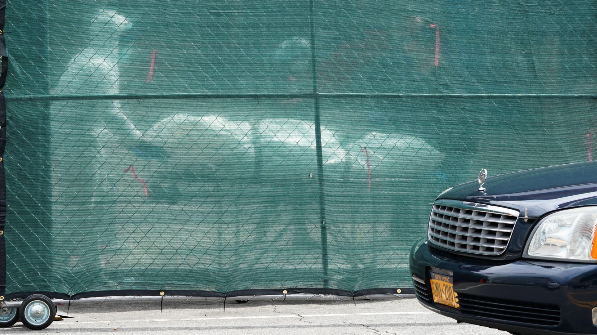 Workers removing a body from a refrigerated truck serving as a temporary morgue at the Brooklyn Hospital Center in New York City.