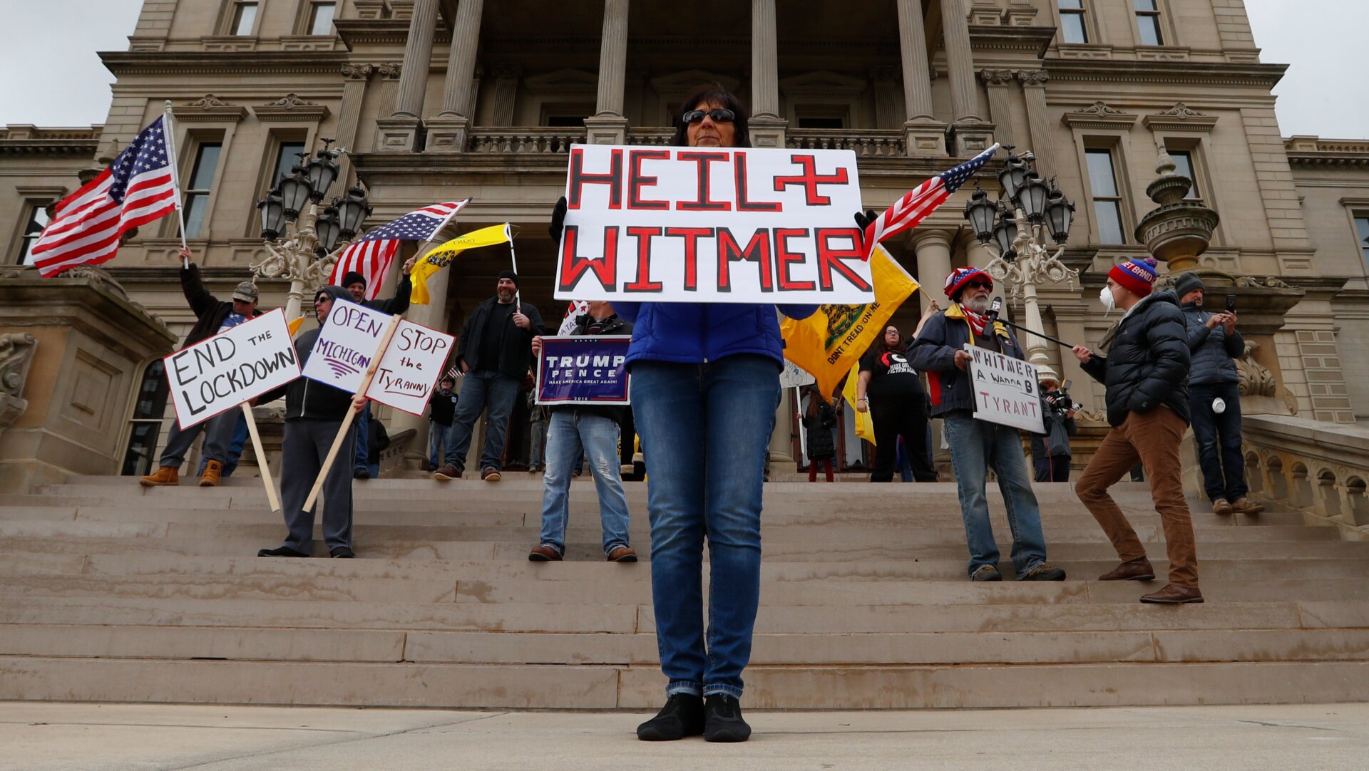 A protester with an... unfortunate sign outside the state house in Michigan on April 15, 2020.