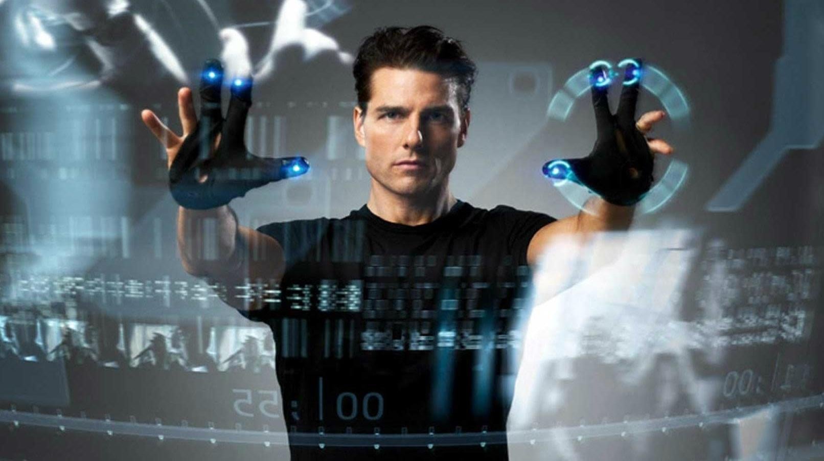 John Anderton (Tom Cruise) demonstrates some new tech for social distancing at work. 