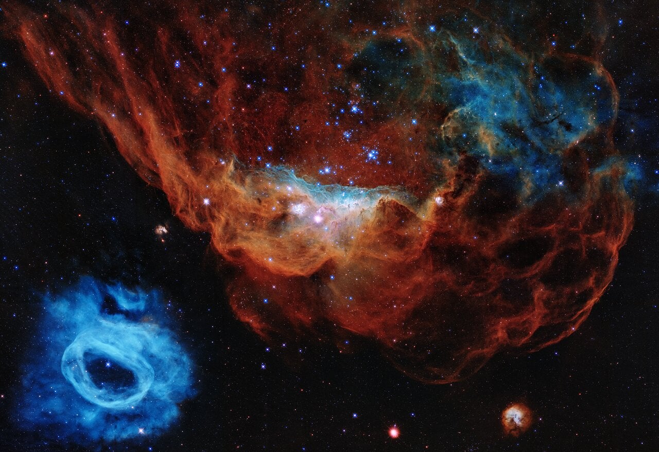 Nebula NGC 2014 (top) and NGC 2020 (bottom left), both located in the Large Magellanic Cloud some 163,000 light-years away.