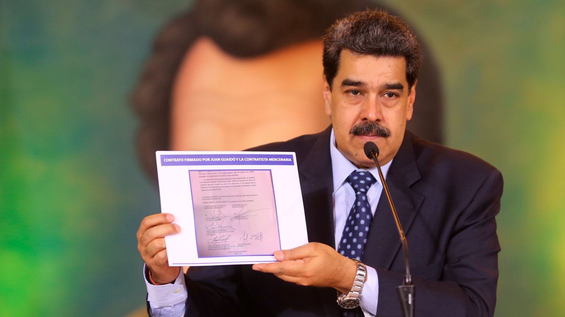 Venezuelan President Nicolas Maduro holding a copy of an alleged contract for U.S. mercenaries to overthrow the nation’s government.