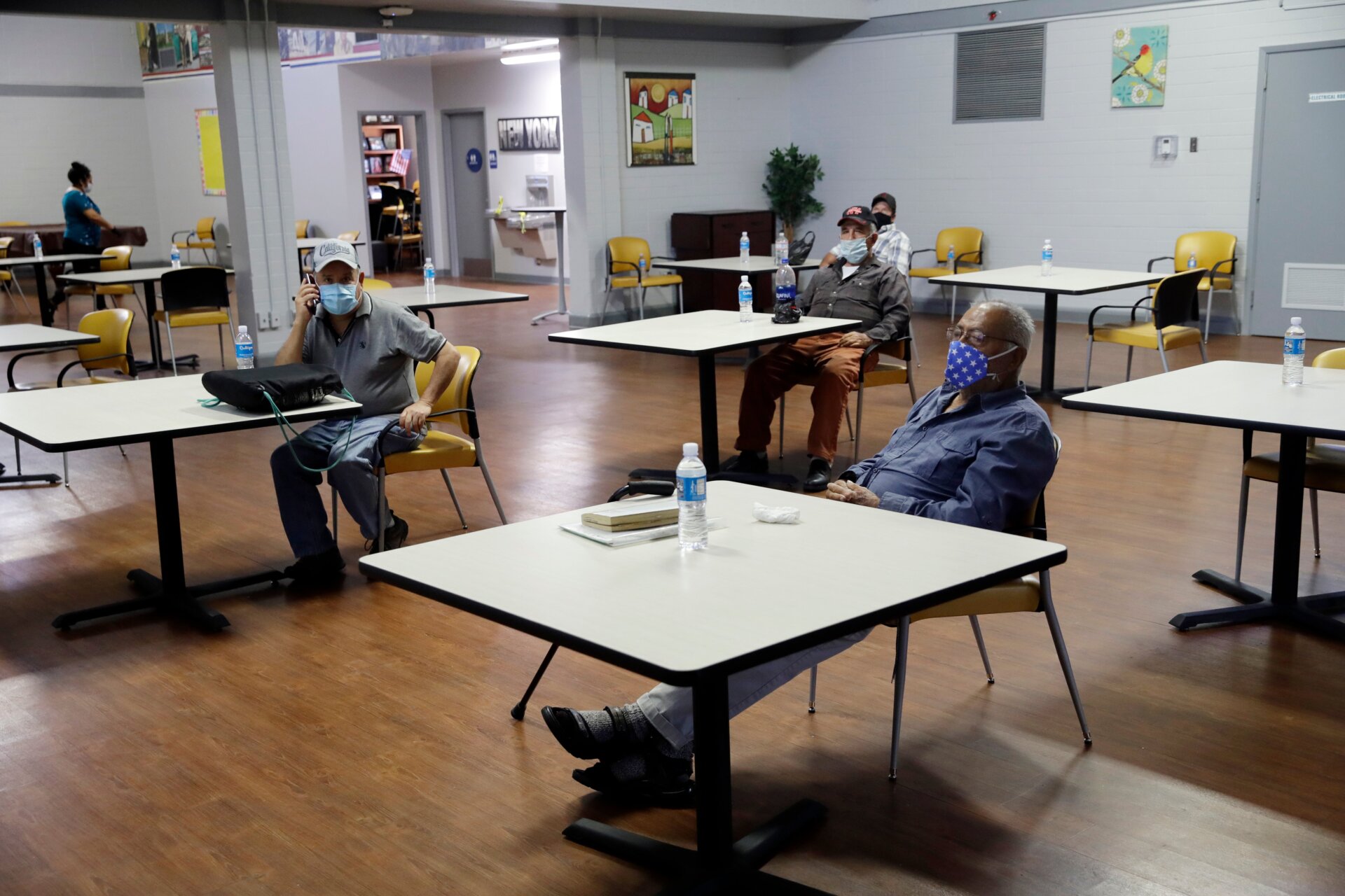 A group of men social distance at a cooling center as temperatures rise amid the pandemic on May 6, 2020, in Los Angeles.