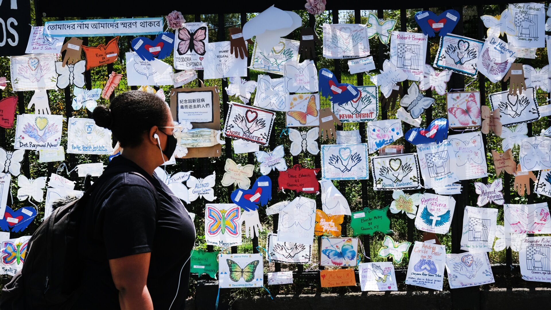 A woman passes by a memorial in Green-Wood Cemetery in Brooklyn, New York, on May 27, 2020.