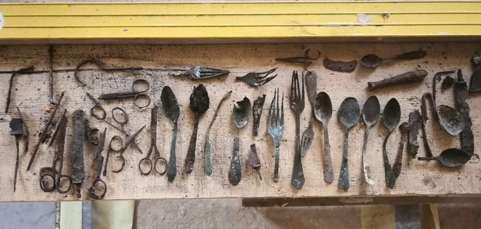Spoons, knives, scissors, and other objects found inside the chimney. 